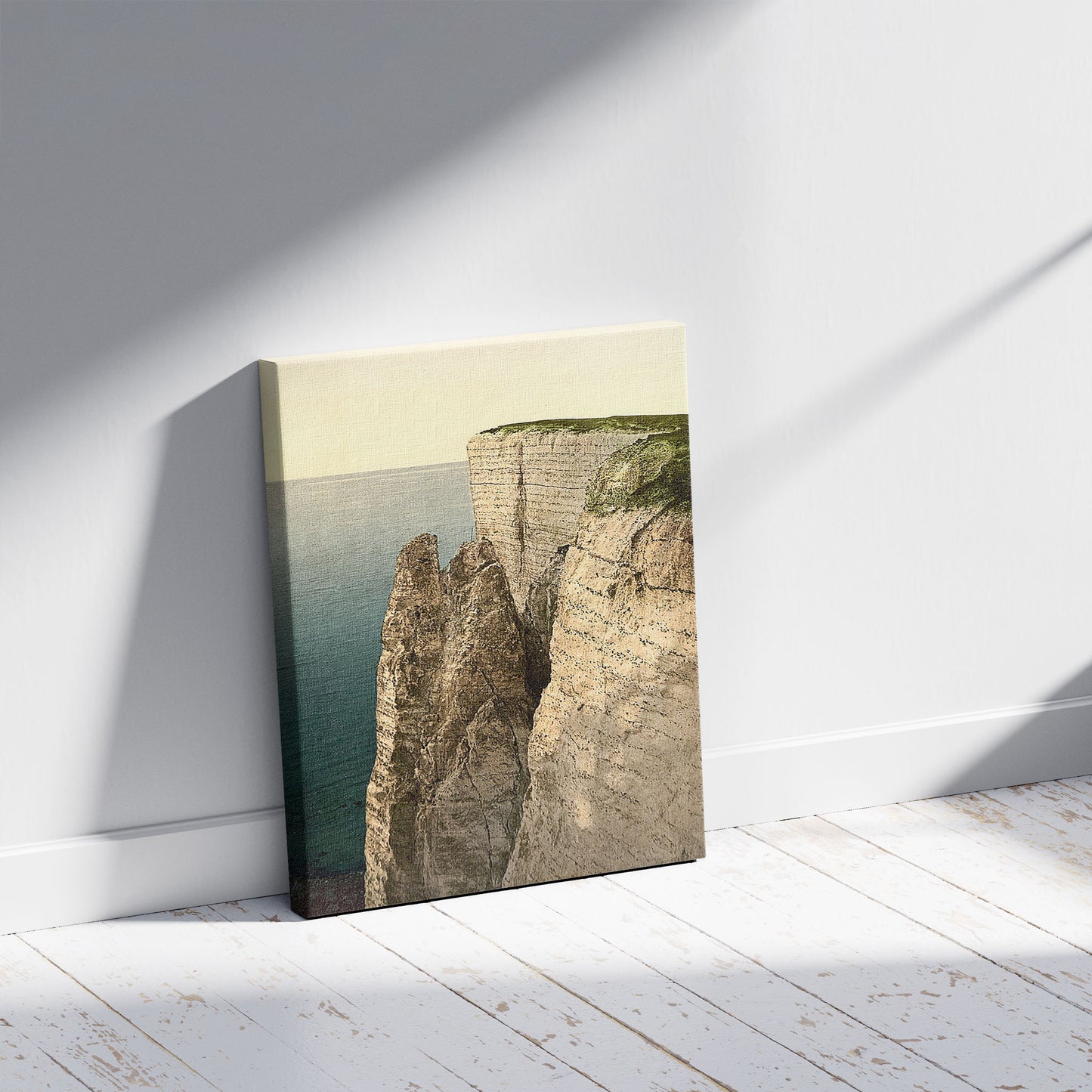 A picture of Beachy Head from above, Eastbourne, England, a mockup of the print leaning against a wall