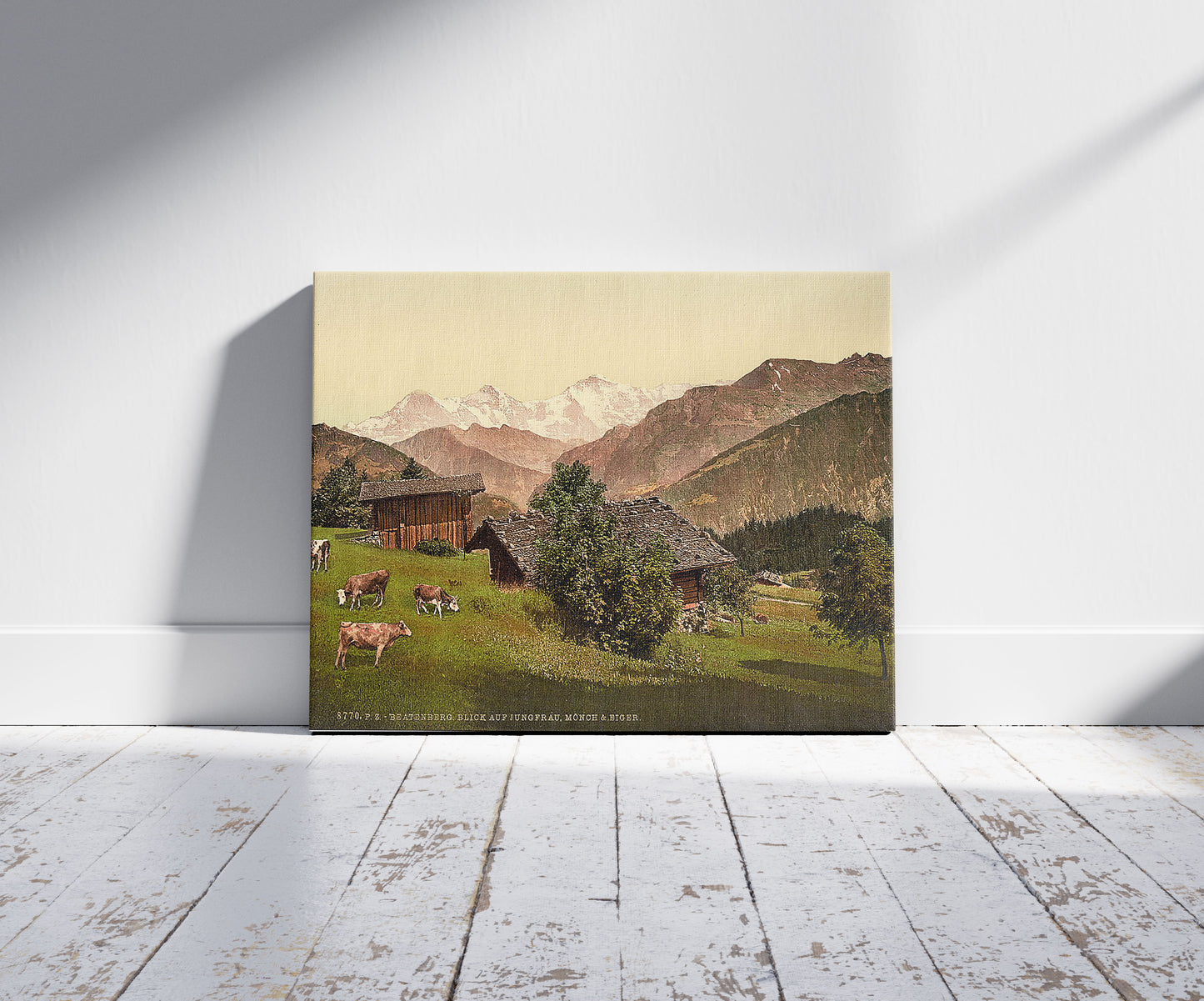 A picture of Beatenburg (i.e., Beatenberg), view of Jungfrau, Monch and Eiger, Bernese Oberland, Switzerland, a mockup of the print leaning against a wall