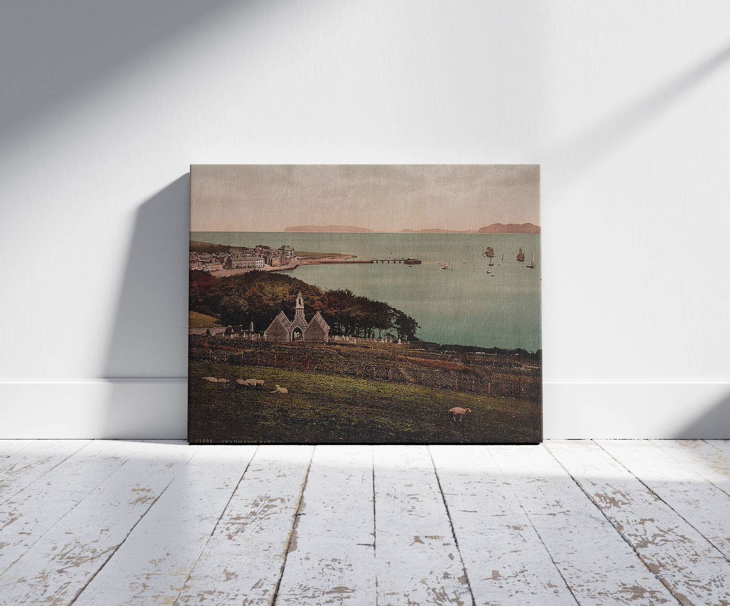 A picture of Beaumaris Bay, Beaumaris Castle, Wales, a mockup of the print leaning against a wall
