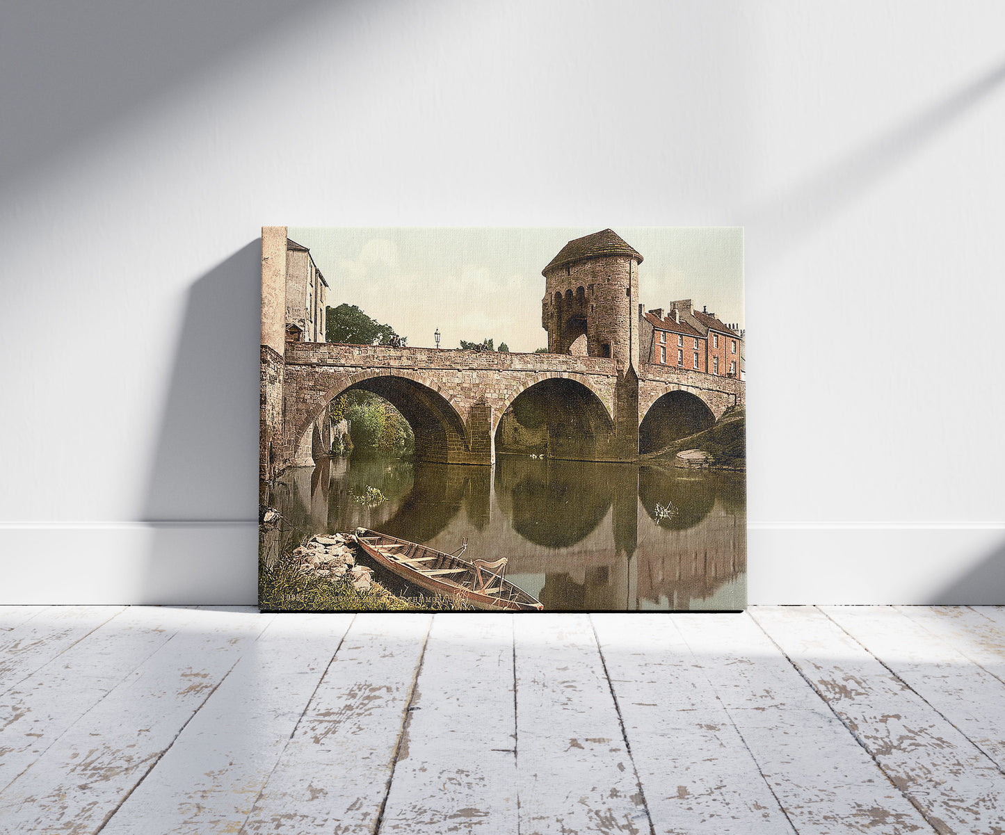 A picture of Bridge over the Monnow, Monmouth, Wales, a mockup of the print leaning against a wall