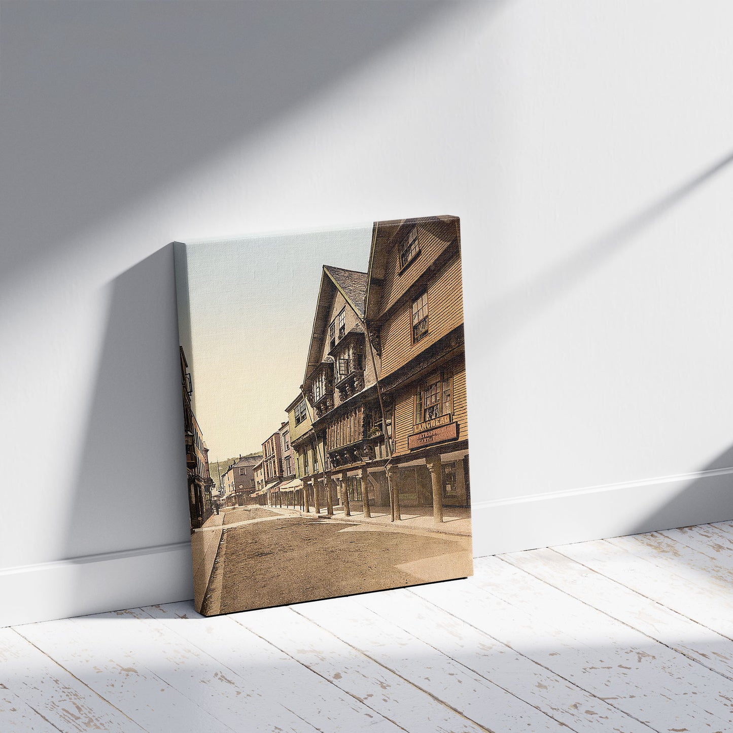 A picture of Butter Walk, Dartmouth, England, a mockup of the print leaning against a wall