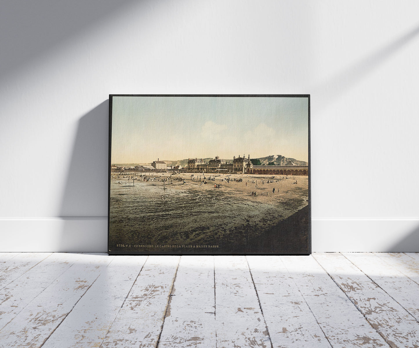 A picture of Casino and beach at low tide, Cherbourg, France, a mockup of the print leaning against a wall