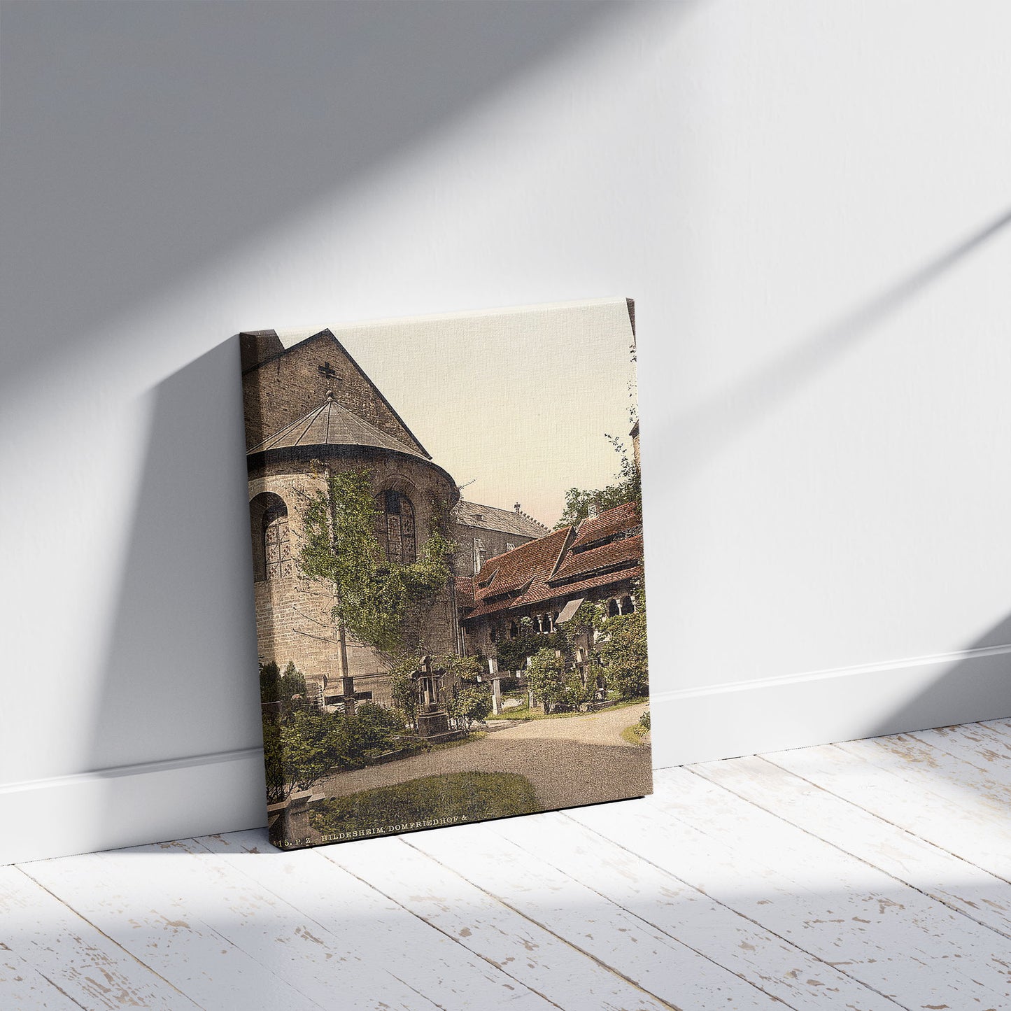 A picture of Cathedral, churchyard and 1,000 year old rose tree, Hildesheim, Hanover, Germany, a mockup of the print leaning against a wall