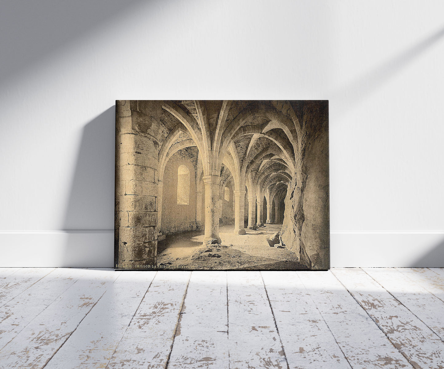 A picture of Chillon Castle, interior, Bonivard's Prison, Geneva Lake, Switzerland, a mockup of the print leaning against a wall