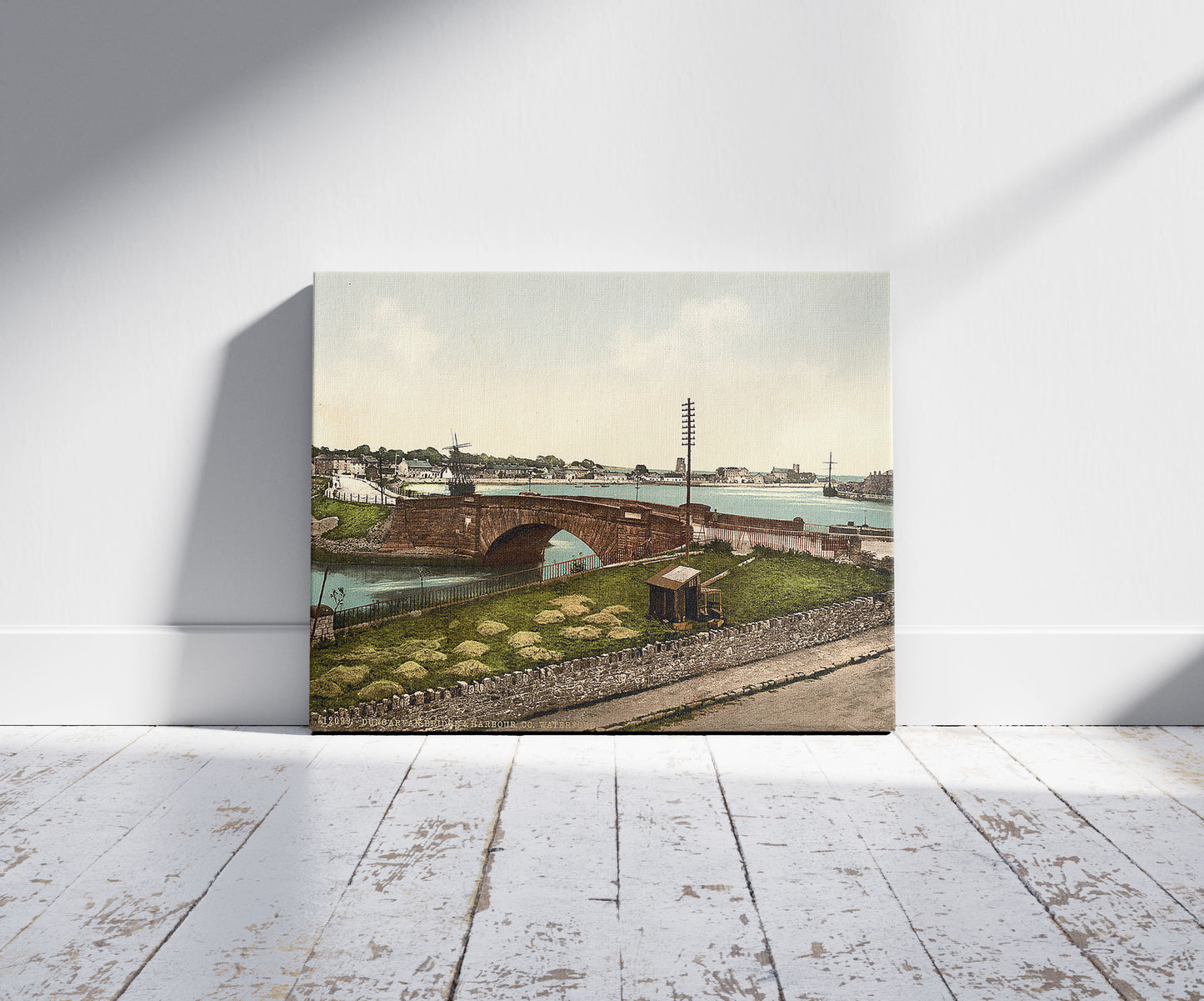 A picture of Dungarven Bridge and Harbor (i.e. Dungarvan). County Waterford, Ireland, a mockup of the print leaning against a wall