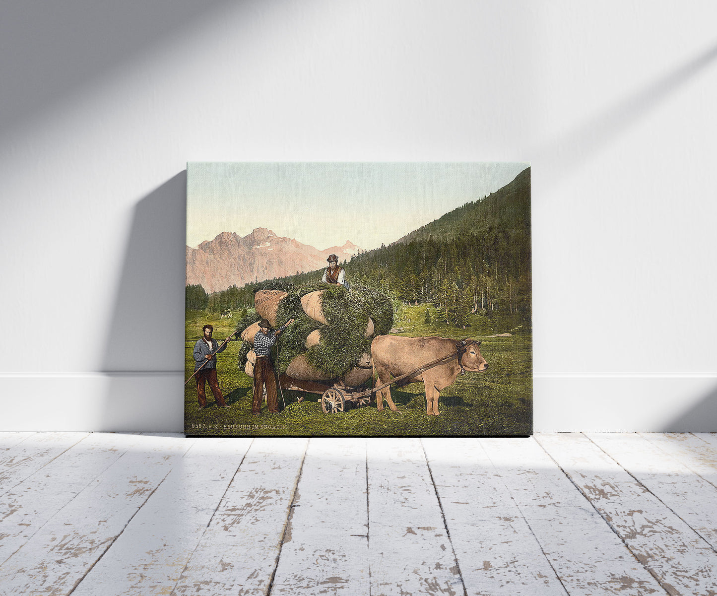 A picture of Engadine, carrying hay in the Engadine, Grisons, Switzerland, a mockup of the print leaning against a wall
