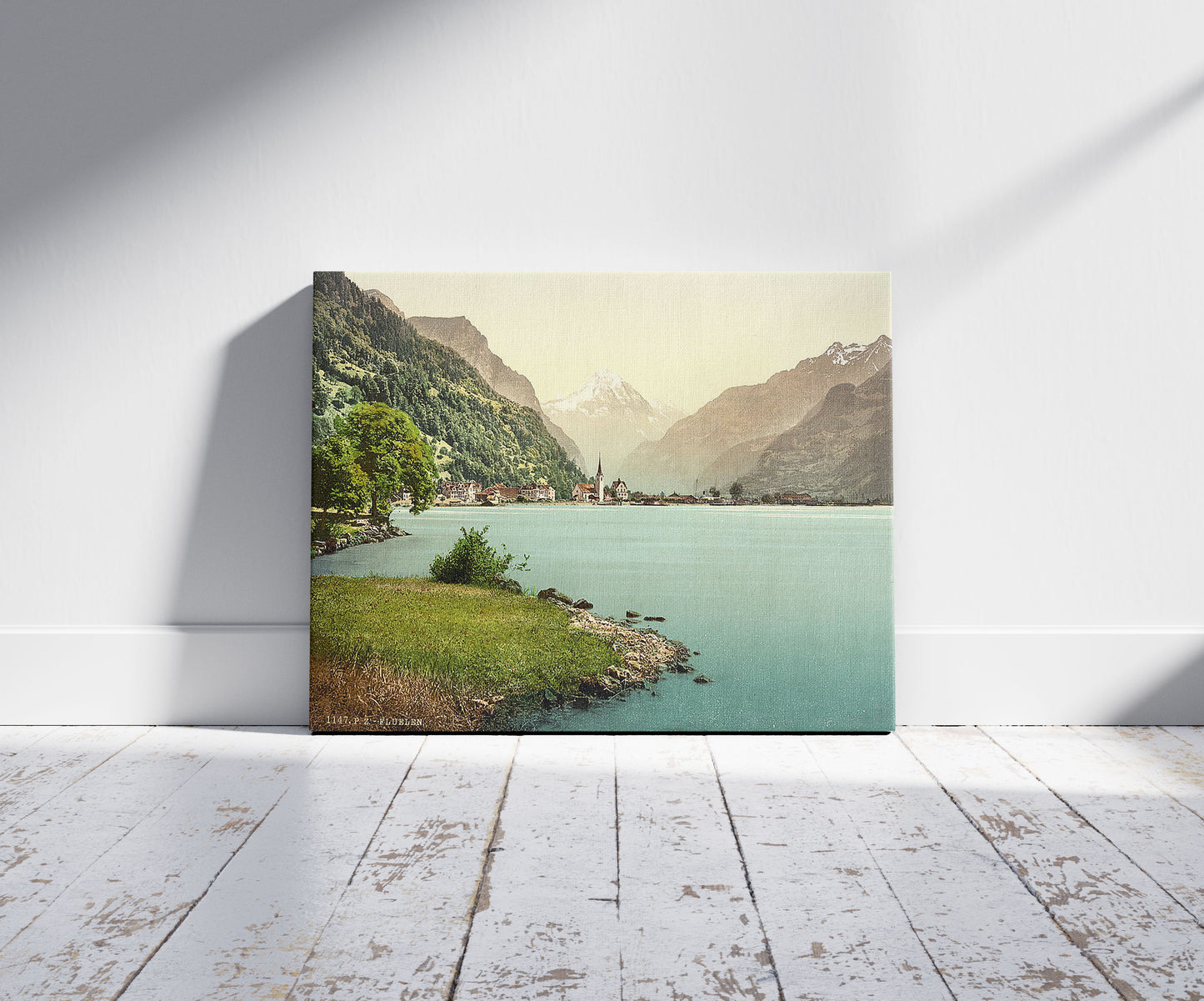 A picture of Fluelen, general view, Lake Lucerne, Switzerland, a mockup of the print leaning against a wall
