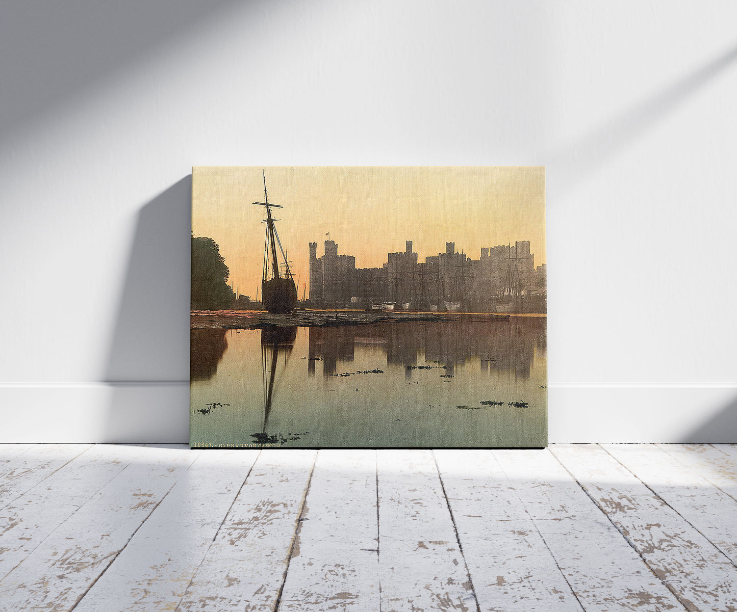 A picture of General view, sunset, Carnarvon Castle (i.e. Caernarfon), Wales, a mockup of the print leaning against a wall