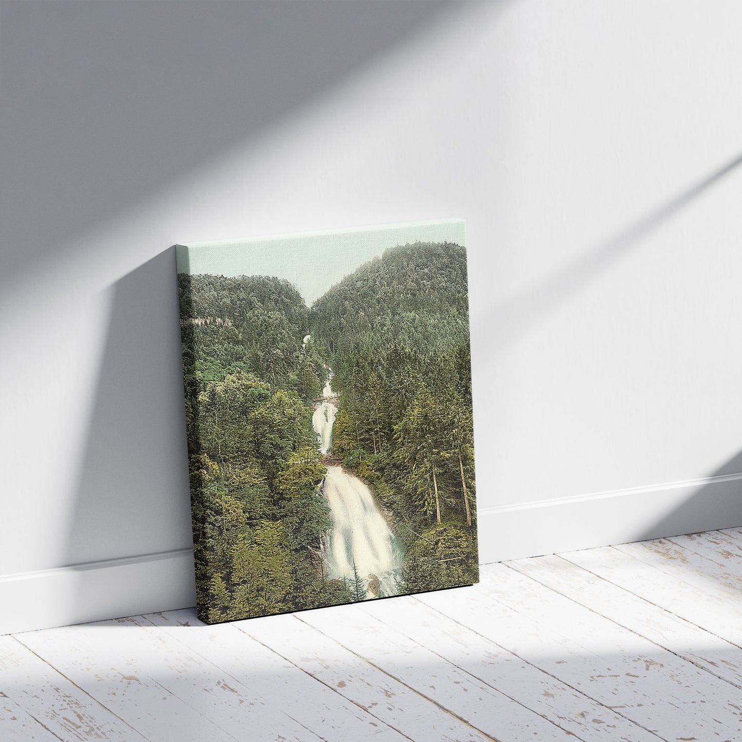 A picture of Giessbach Cascade, Bernese Oberland, Switzerland, a mockup of the print leaning against a wall