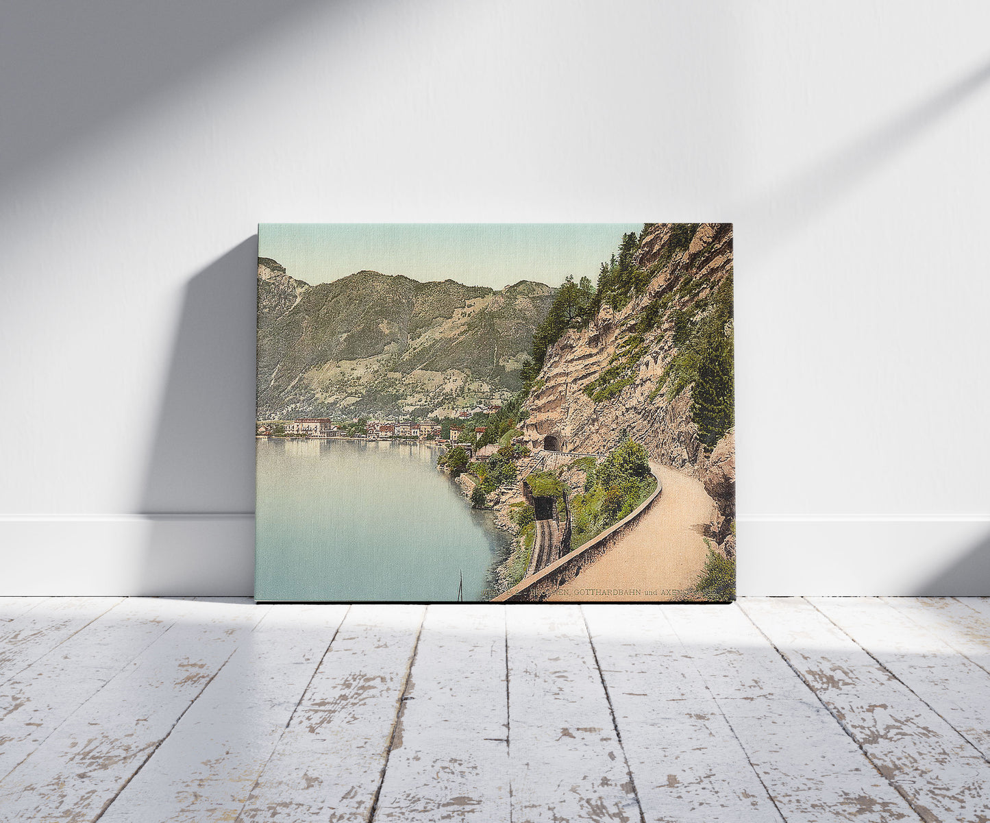 A picture of Gothard Tunnel and the Axenstrasse, Lake Lucerne, Switzerland, a mockup of the print leaning against a wall