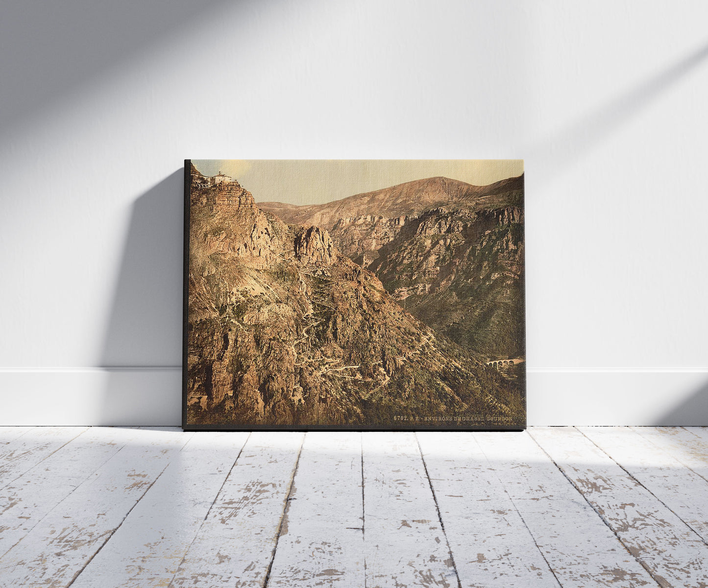 A picture of Gourdon, Grasse, France, a mockup of the print leaning against a wall