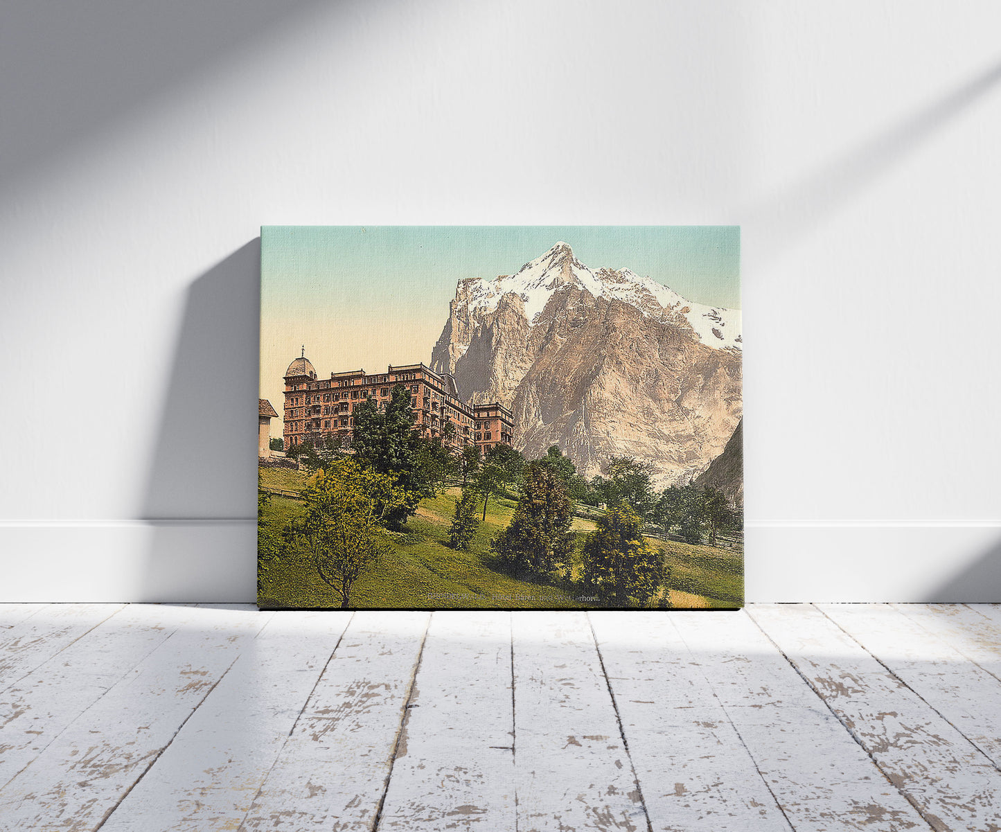 A picture of Grindelwald, view of Hotel Bären and Wetterhorn Mountain, Bernese Oberland, Switzerland, a mockup of the print leaning against a wall