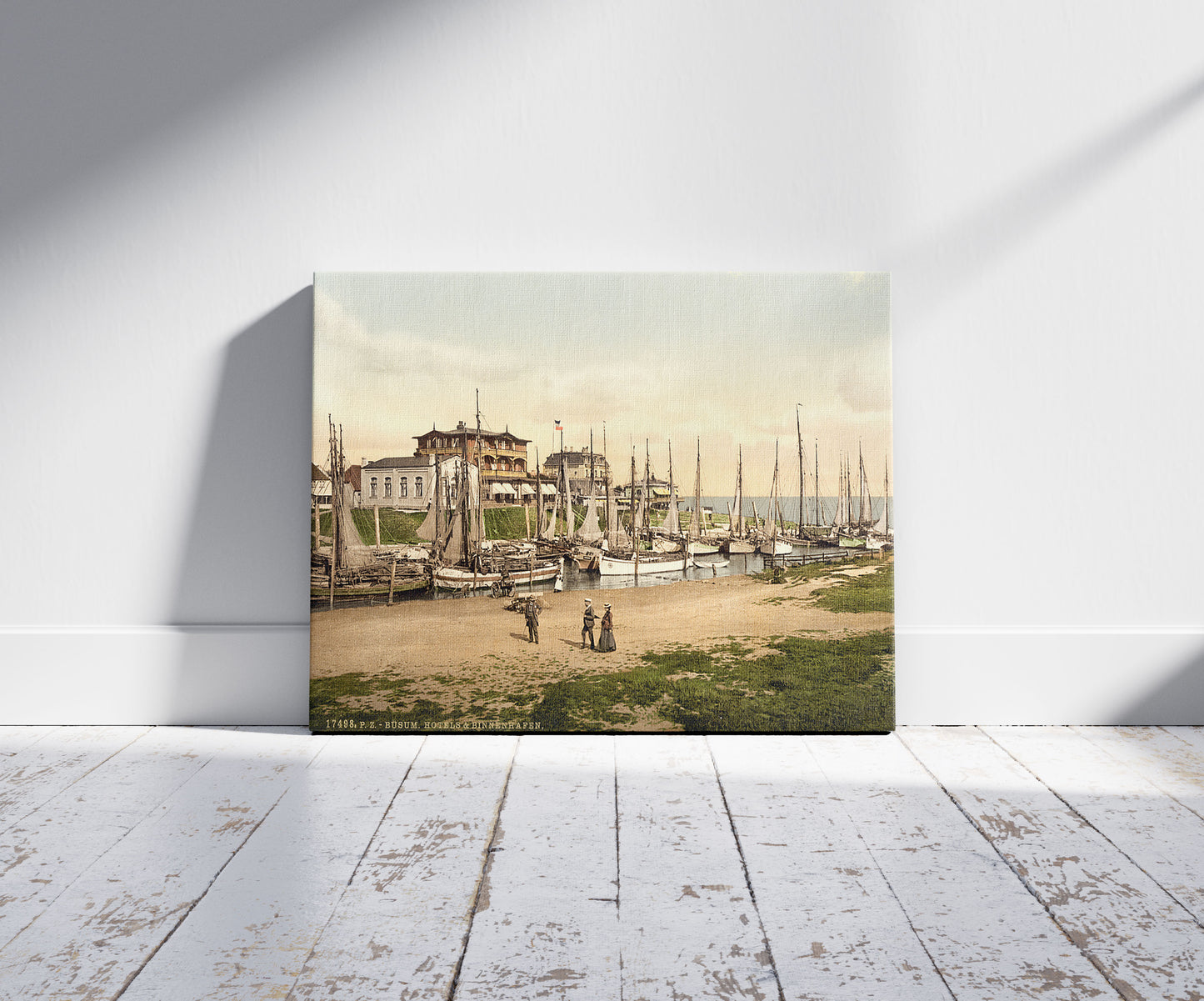 A picture of Hotels and inland harbor, Busum, Schleswig-Holstein, Germany, a mockup of the print leaning against a wall
