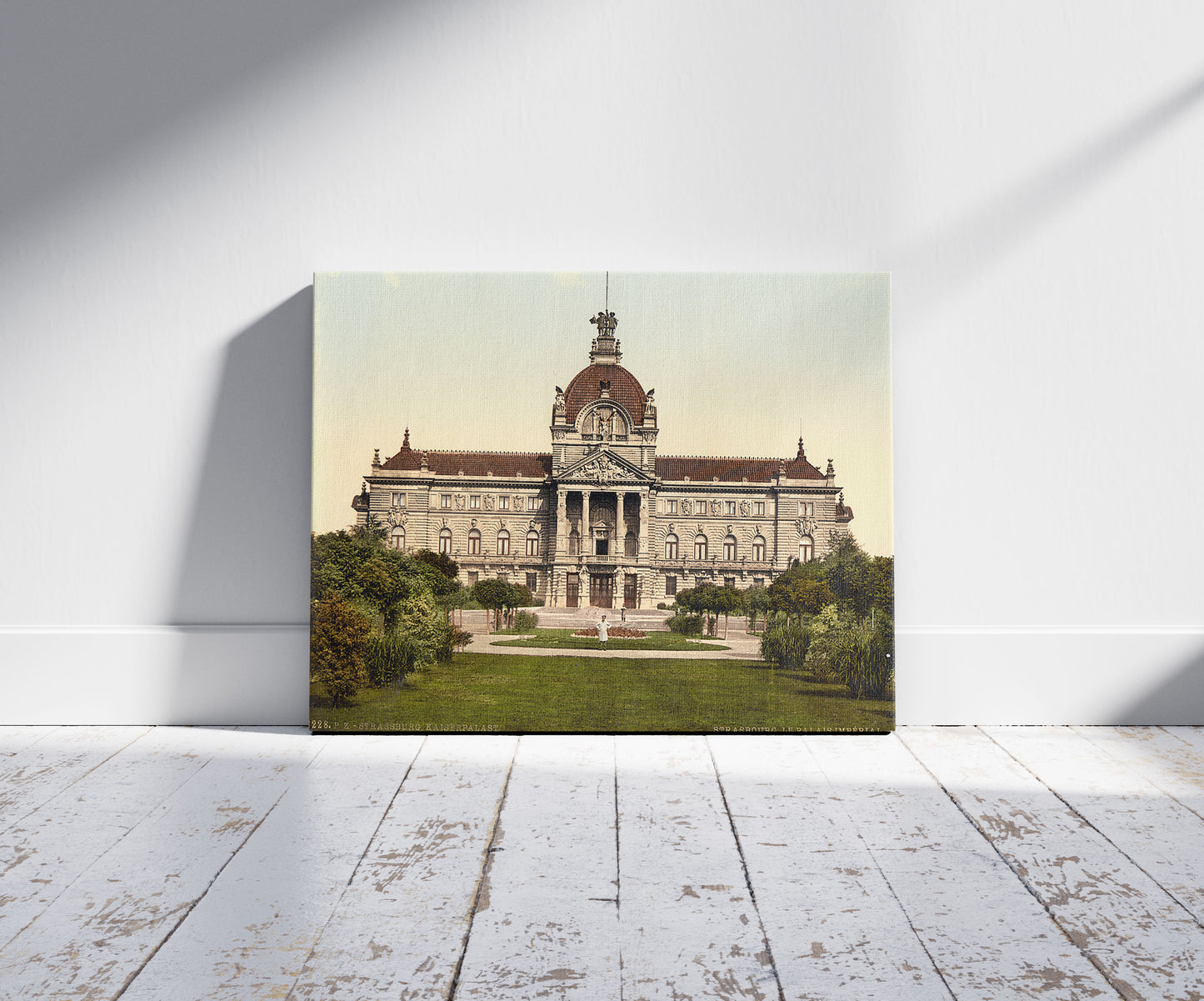 A picture of Imperial Palace, Strassburg, Alsace Lorraine, Germany, a mockup of the print leaning against a wall