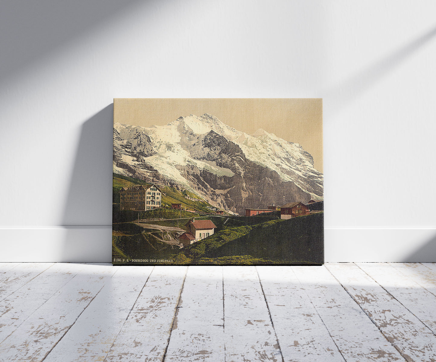 A picture of Jungfrau and Scheidegg, Bernese Oberland, Switzerland, a mockup of the print leaning against a wall