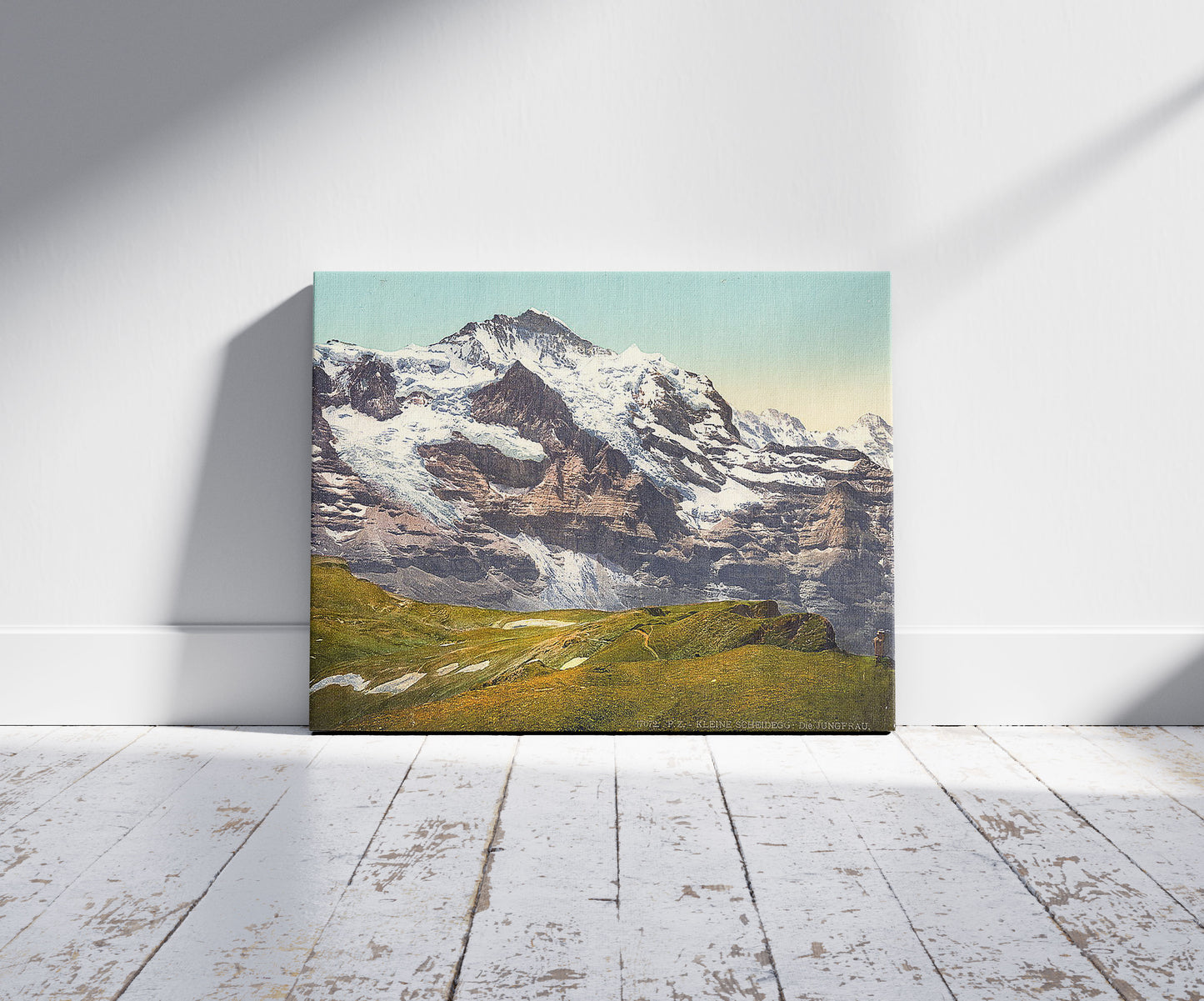 A picture of Jungfrau and Scheidegg, Bernese Oberland, Switzerland, a mockup of the print leaning against a wall