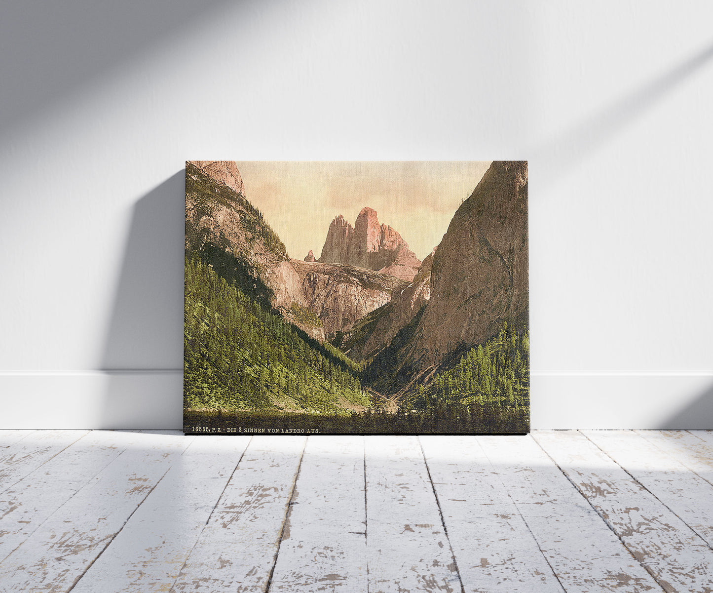 A picture of Landro, the Three Spires (i.e., Drei Zinnen), Tyrol, Austro-Hungary, a mockup of the print leaning against a wall