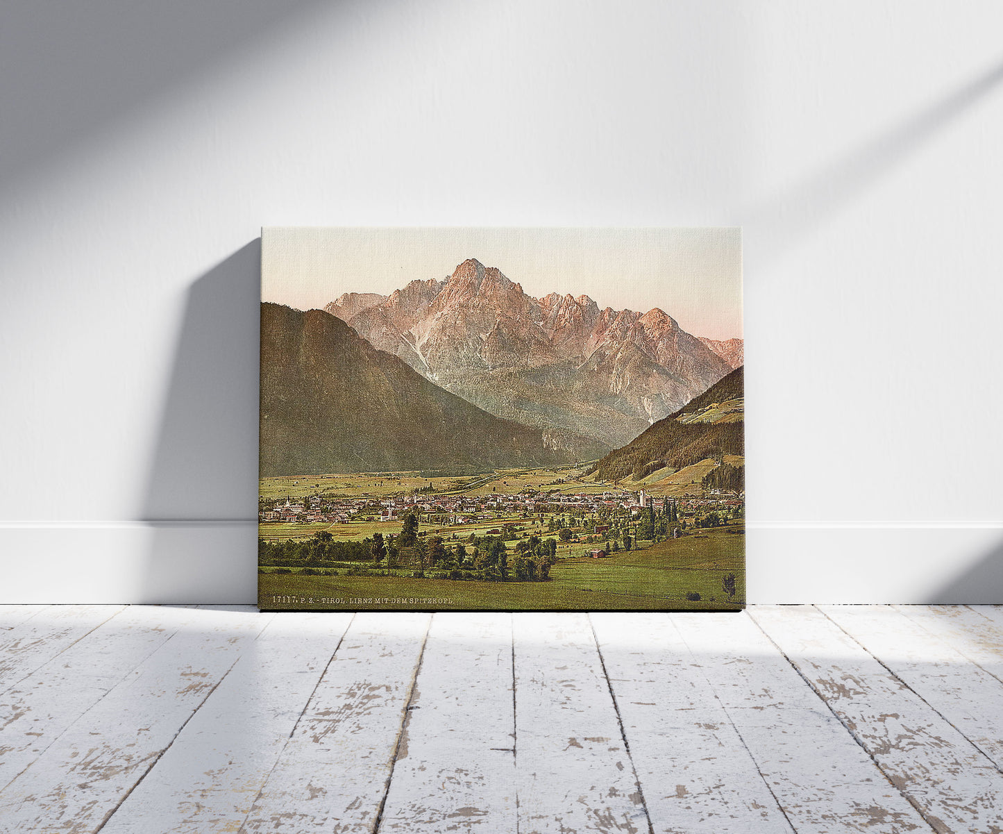 A picture of Lienz, with the Spitzkolft (i.e., Spitzkofl), Tyrol, Austro-Hungary, a mockup of the print leaning against a wall