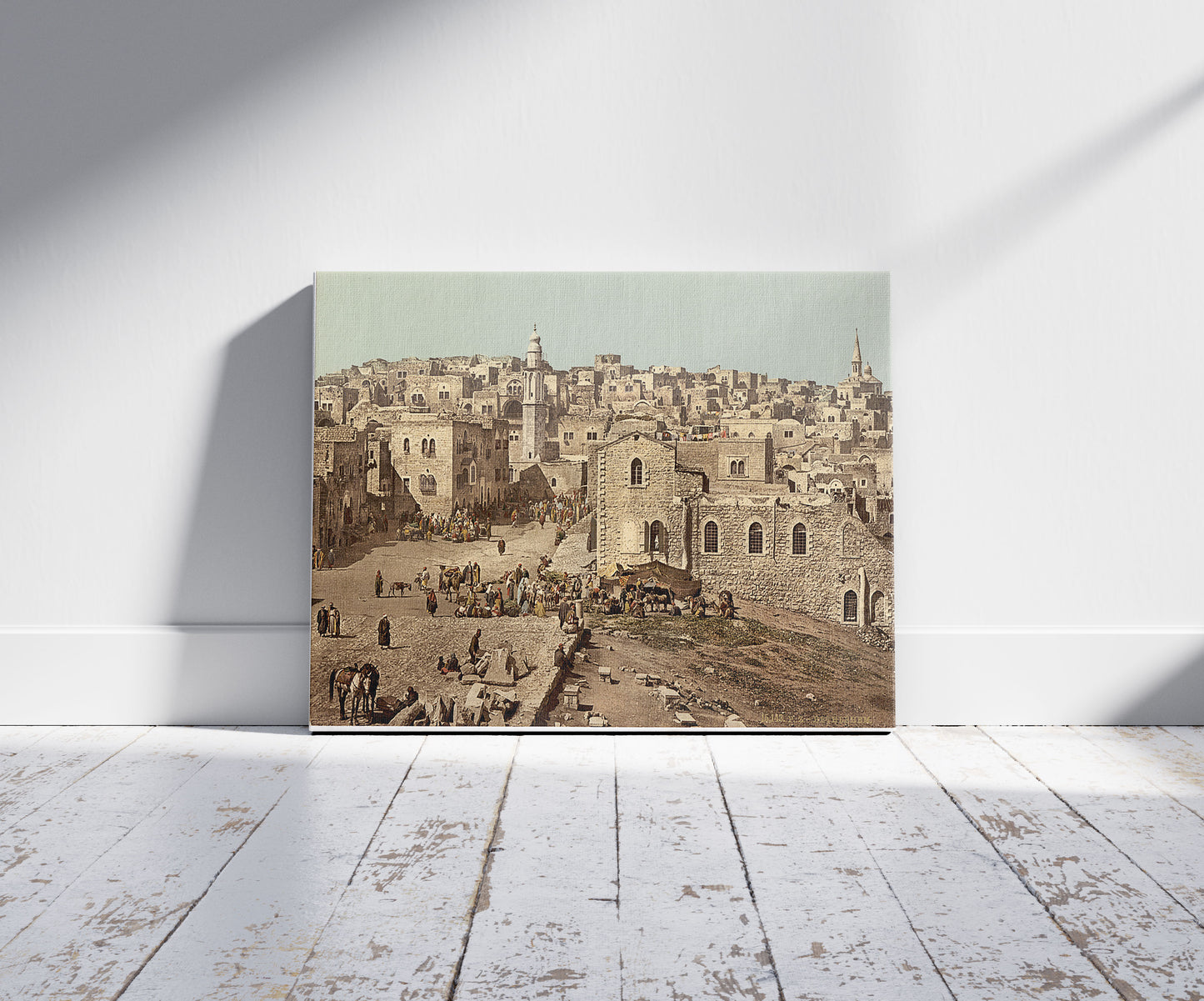 A picture of Market Place, Bethlehem, Holy Land, (i.e., West Bank), a mockup of the print leaning against a wall