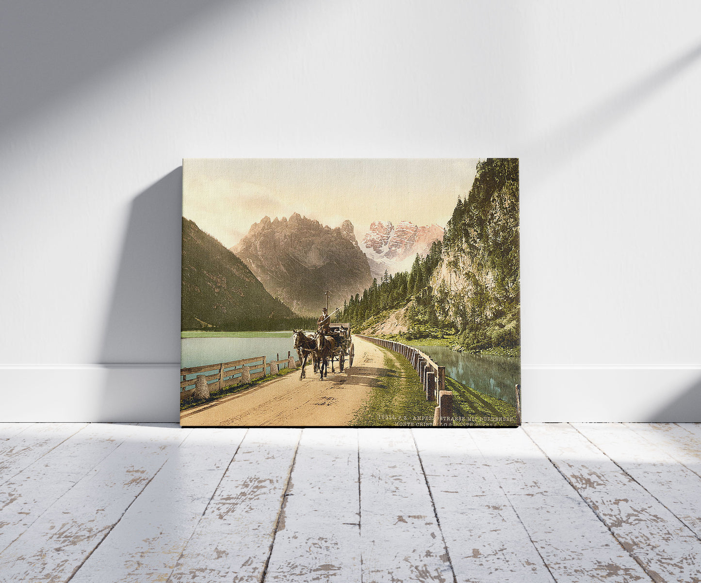 A picture of Monte Cristallo and Mont Popena, Ampezzostrasse with Durrensee, Tyrol, Austro-Hungary, a mockup of the print leaning against a wall