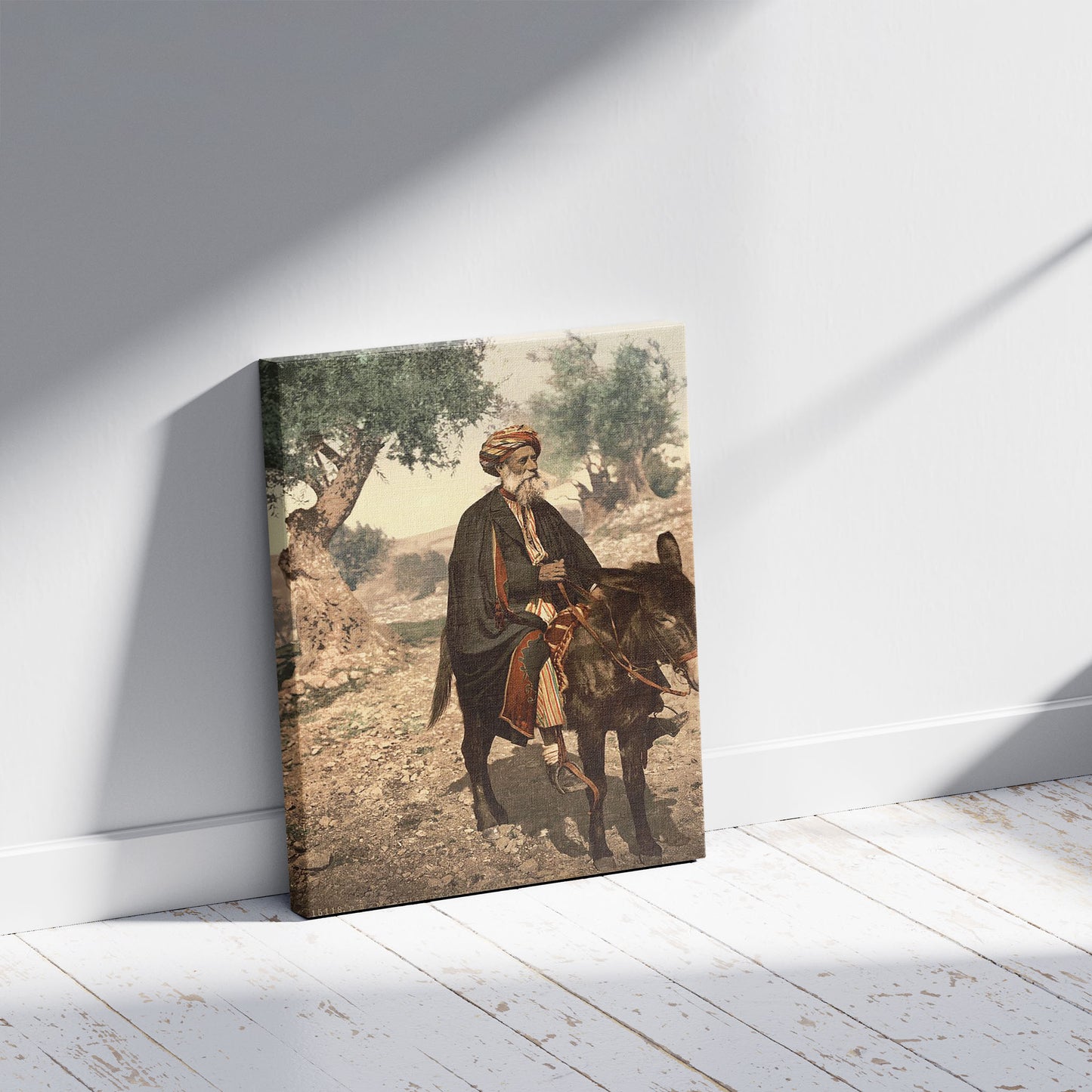 A picture of Native of Bethlehem on his donkey, Holy Land, (i.e., West Bank), a mockup of the print leaning against a wall