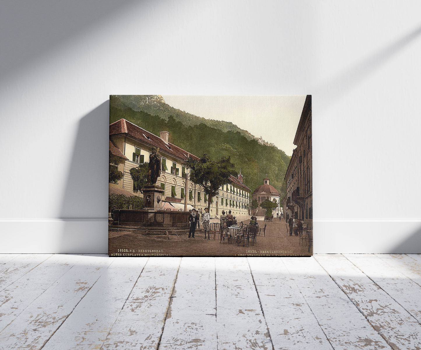 A picture of Old Kurplatz and Military Hospital, Herkulesfürdö, Hungary, Austro-Hungary, a mockup of the print leaning against a wall