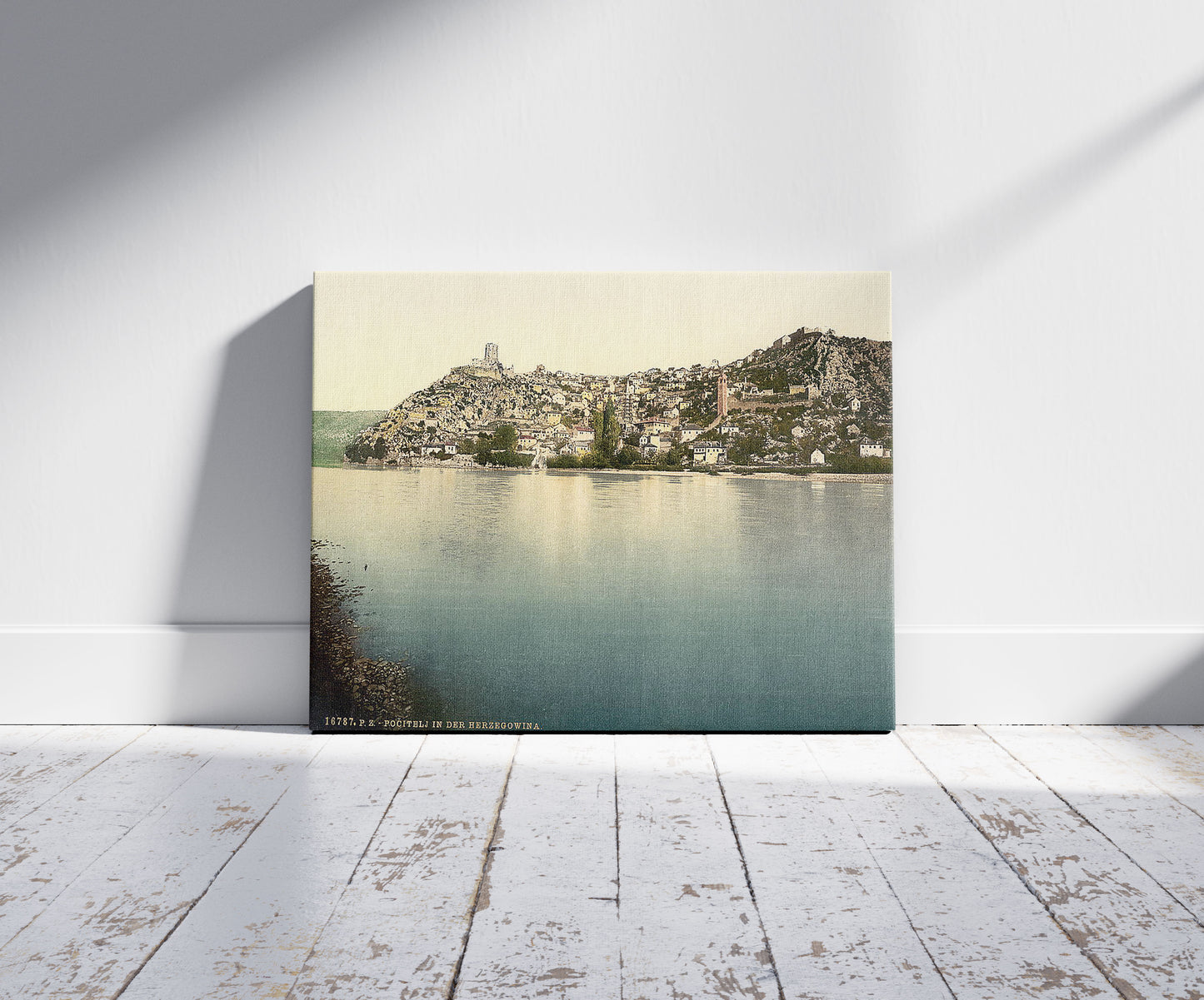 A picture of Pocitelj, general view, Herzegowina, Austro-Hungary, a mockup of the print leaning against a wall
