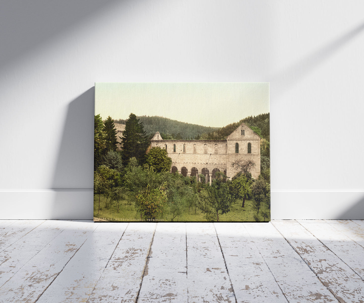 A picture of Ruins of the convent, Paulinzella, Thuringia, Germany, a mockup of the print leaning against a wall