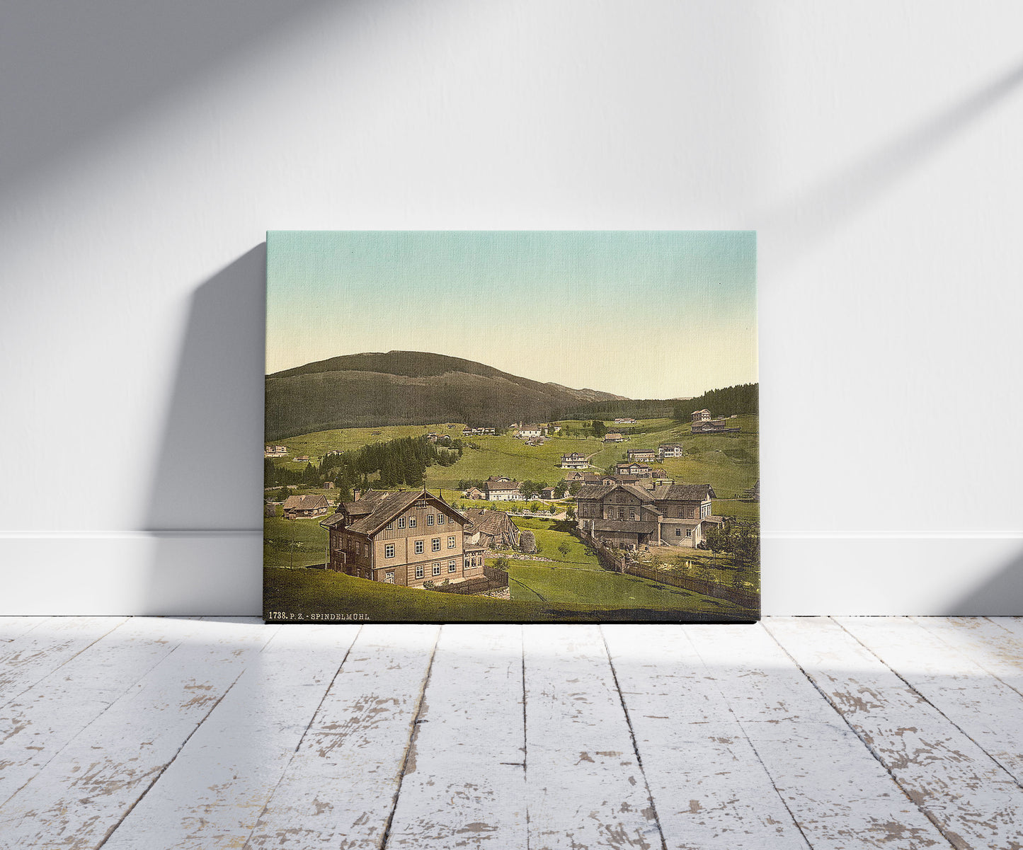 A picture of Spindelmuhl, Riesengebirge, Germany (i.e.,Špindlerův Mlýn, Czech Republic), a mockup of the print leaning against a wall