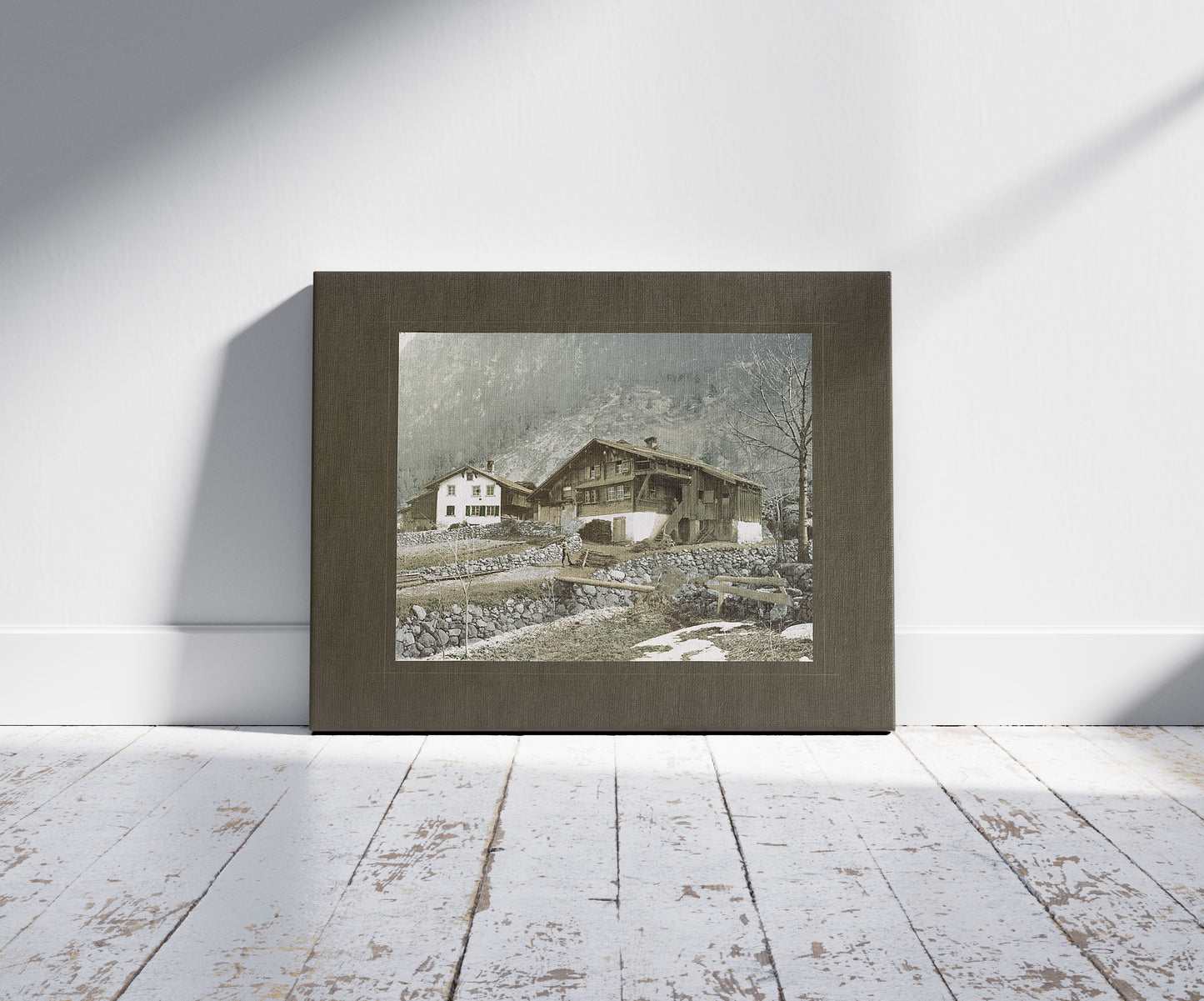 A picture of Swiss chalet, a mockup of the print leaning against a wall