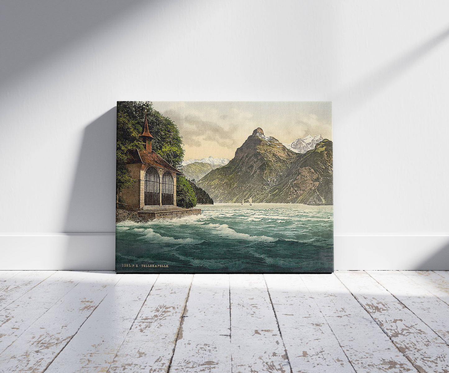A picture of Tell's Chapel, Lake Lucerne, Switzerland, a mockup of the print leaning against a wall