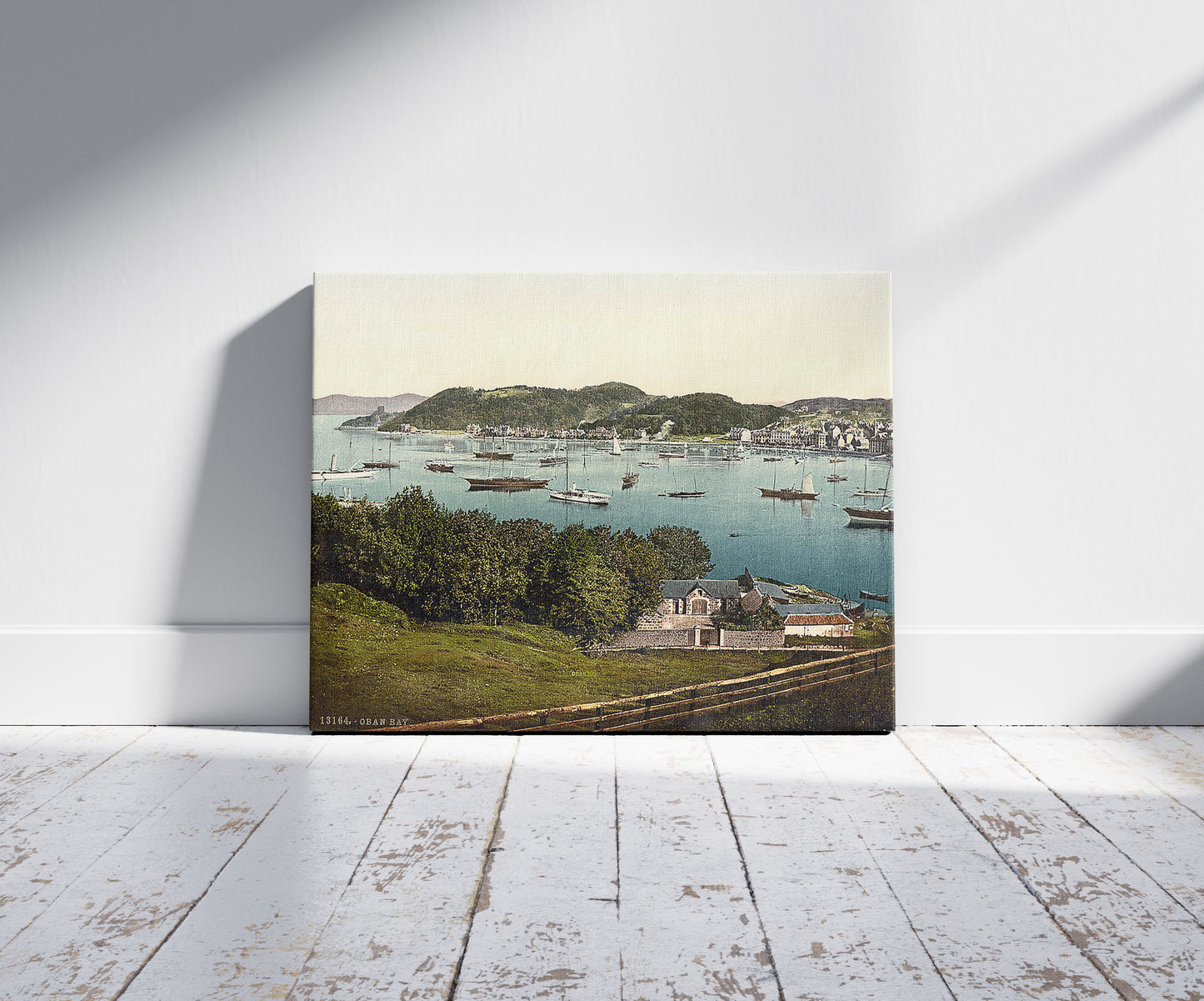 A picture of The bay, Oban, Scotland, a mockup of the print leaning against a wall