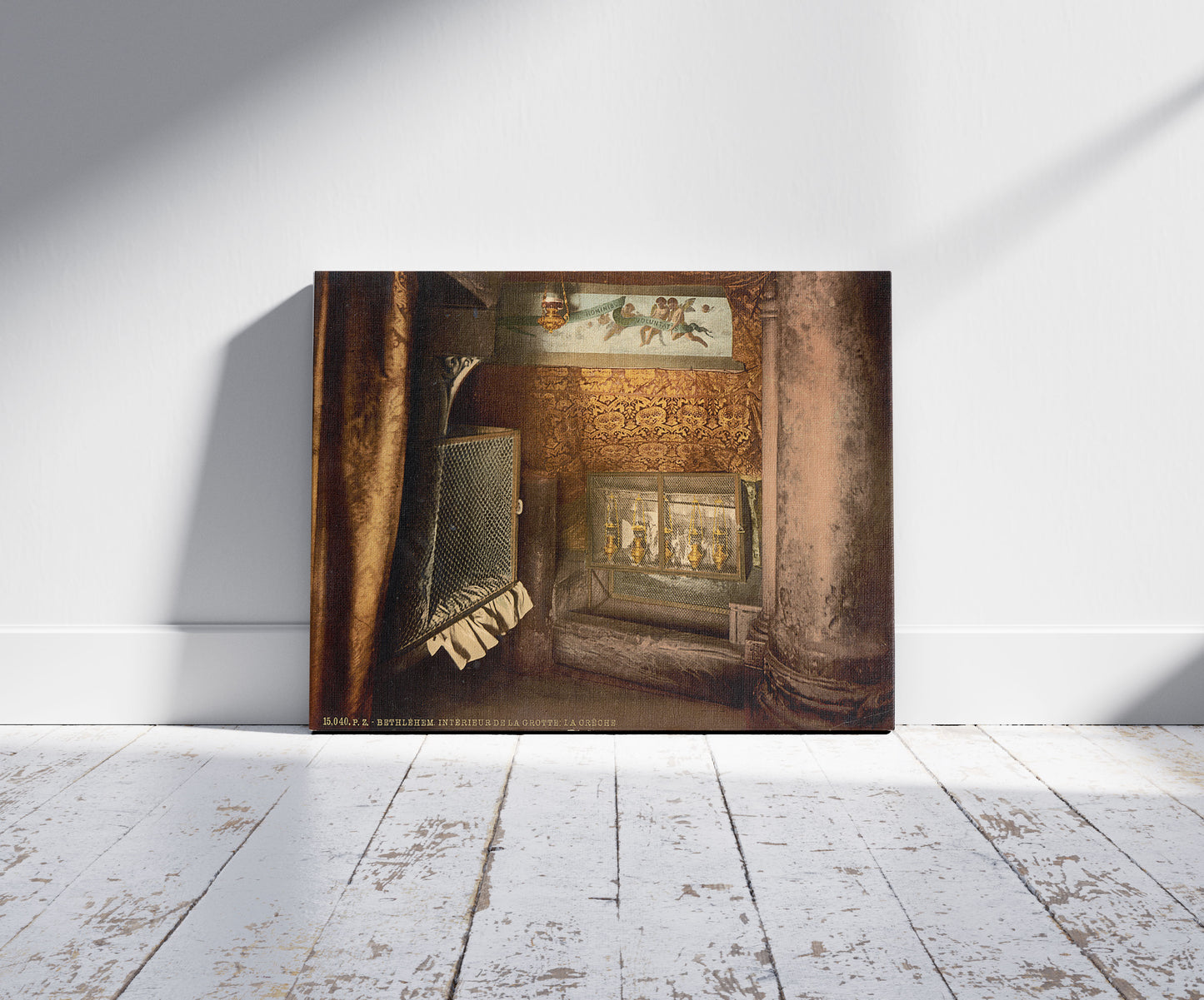 A picture of The cave and the cradle, Bethlehem, Holy Land, (i.e., West Bank), a mockup of the print leaning against a wall