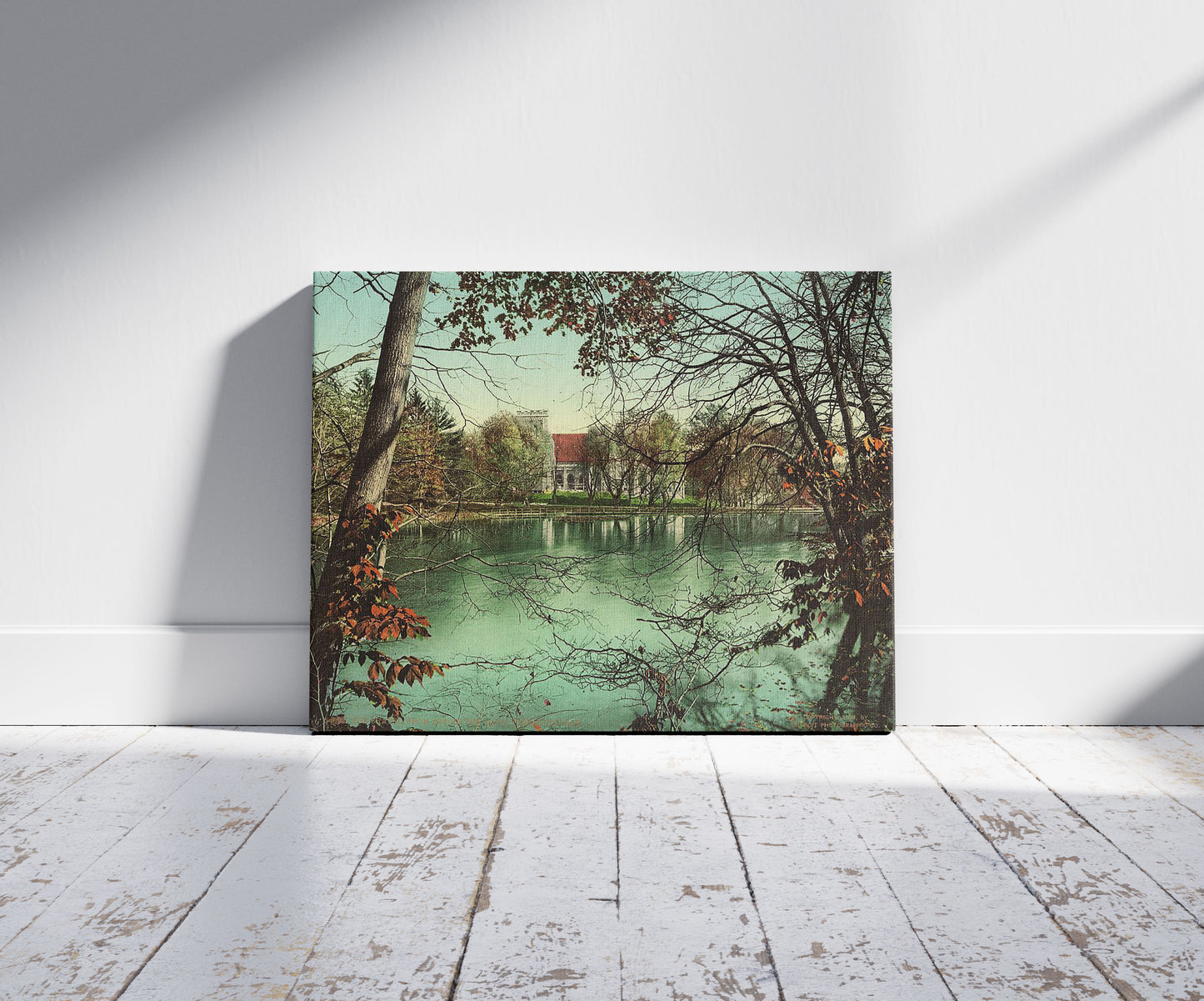 A picture of The chapel from across the lake, Vassar College, a mockup of the print leaning against a wall