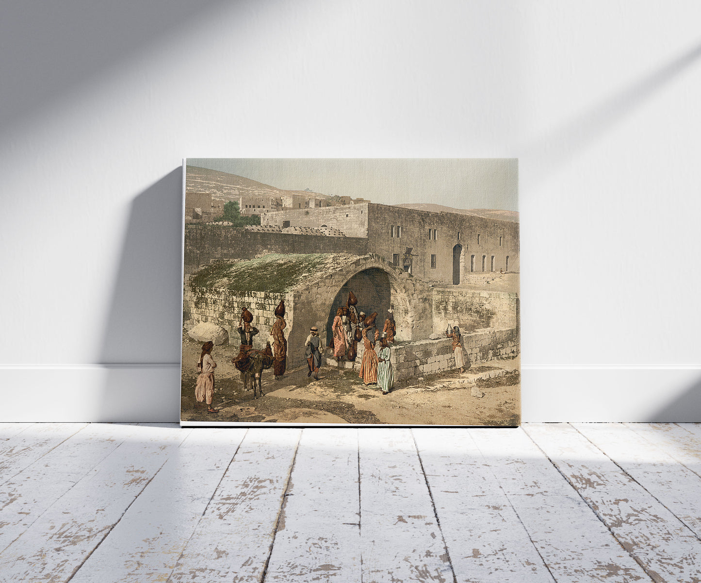 A picture of The virgin's fountain, Nazareth, Holy Land, (i.e. Israel), a mockup of the print leaning against a wall