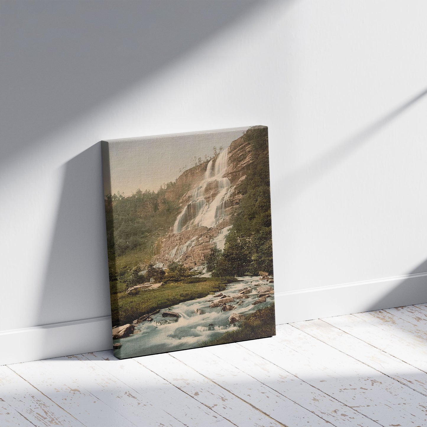 A picture of Tvindefos (i.e., Tvindefossen) Norway, a mockup of the print leaning against a wall