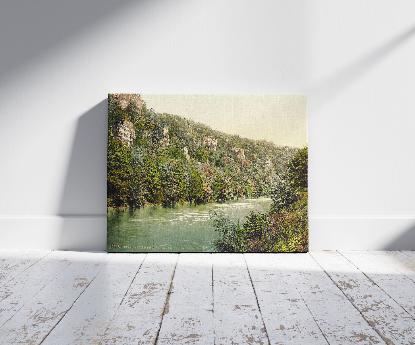A picture of Vicinity of Seven Sisters' Rocks, River Wye, Monmouth, Wales, a mockup of the print leaning against a wall