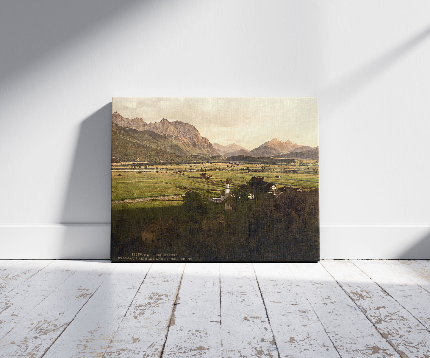 A picture of Walgau and Krim with Karwendelgebirge, Upper Bavaria, Germany, a mockup of the print leaning against a wall