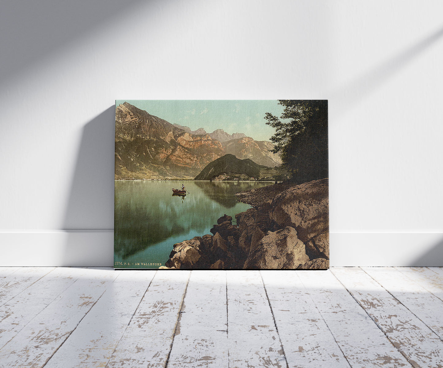 A picture of Wallenstadt Lake, and view of the town, St. Gall, Switzerland, a mockup of the print leaning against a wall