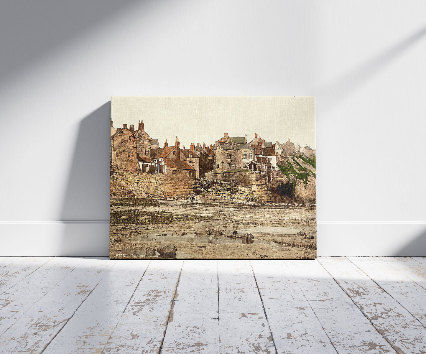 A picture of Whitby, Robin Hood's Bay, Yorkshire, England, a mockup of the print leaning against a wall