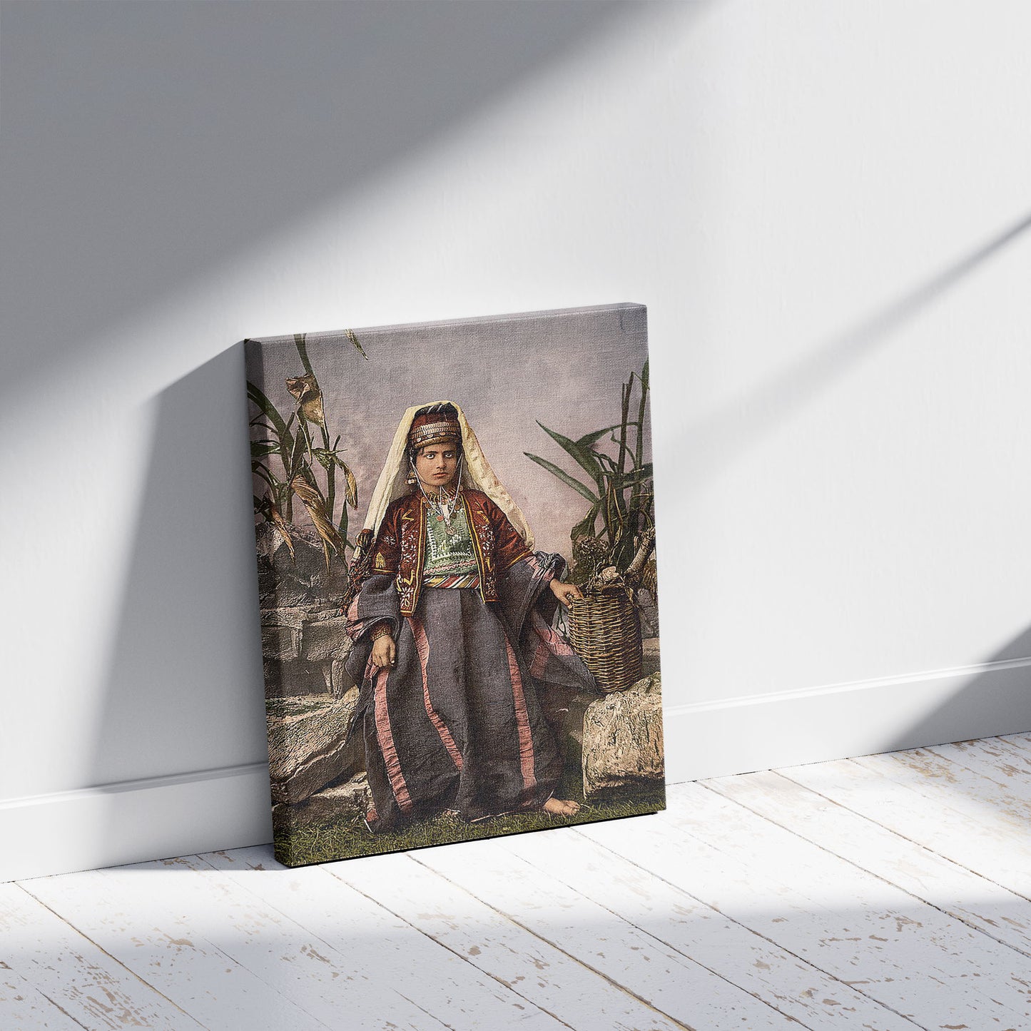 A picture of Young women of Bethlehem, Holy Land, (i.e., West Bank), a mockup of the print leaning against a wall