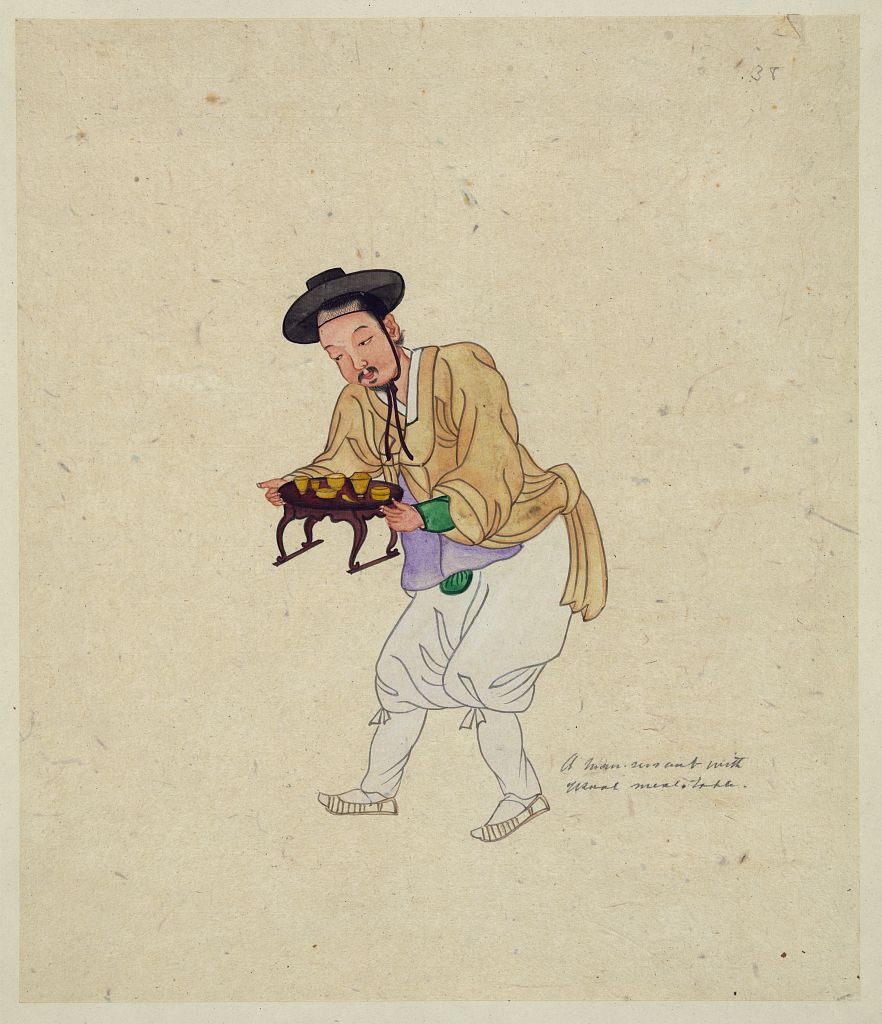 A picture of A man servant with usual meal table