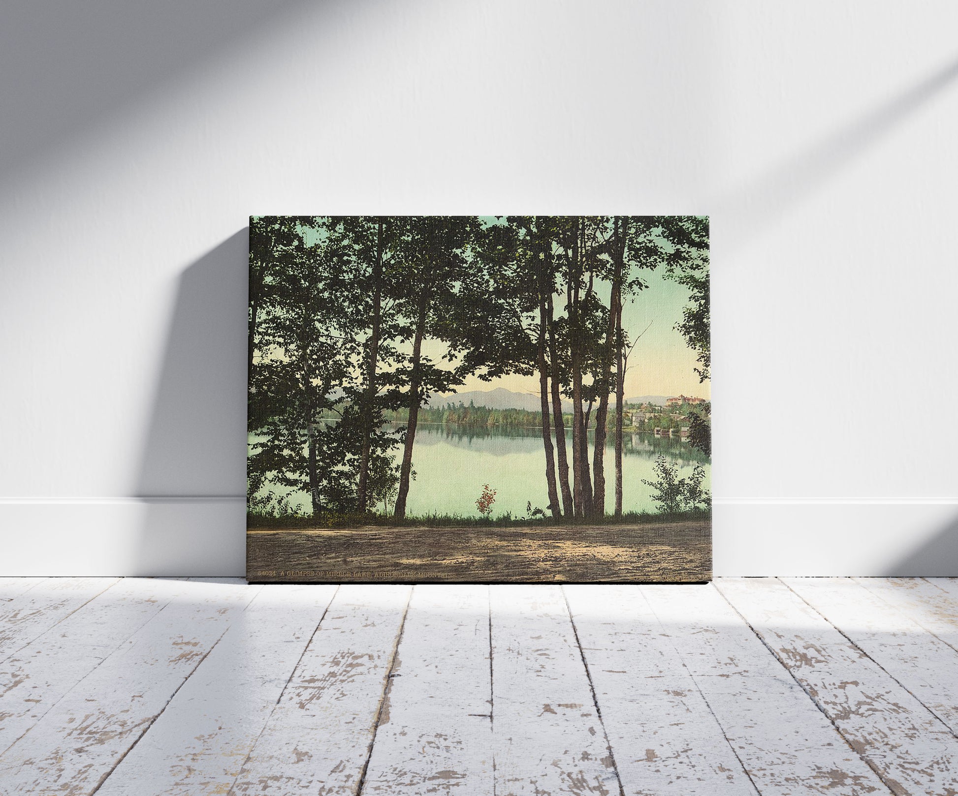 A picture of A glimpse of Mirror Lake, Adirondack Mountains, a mockup of the print leaning against a wall