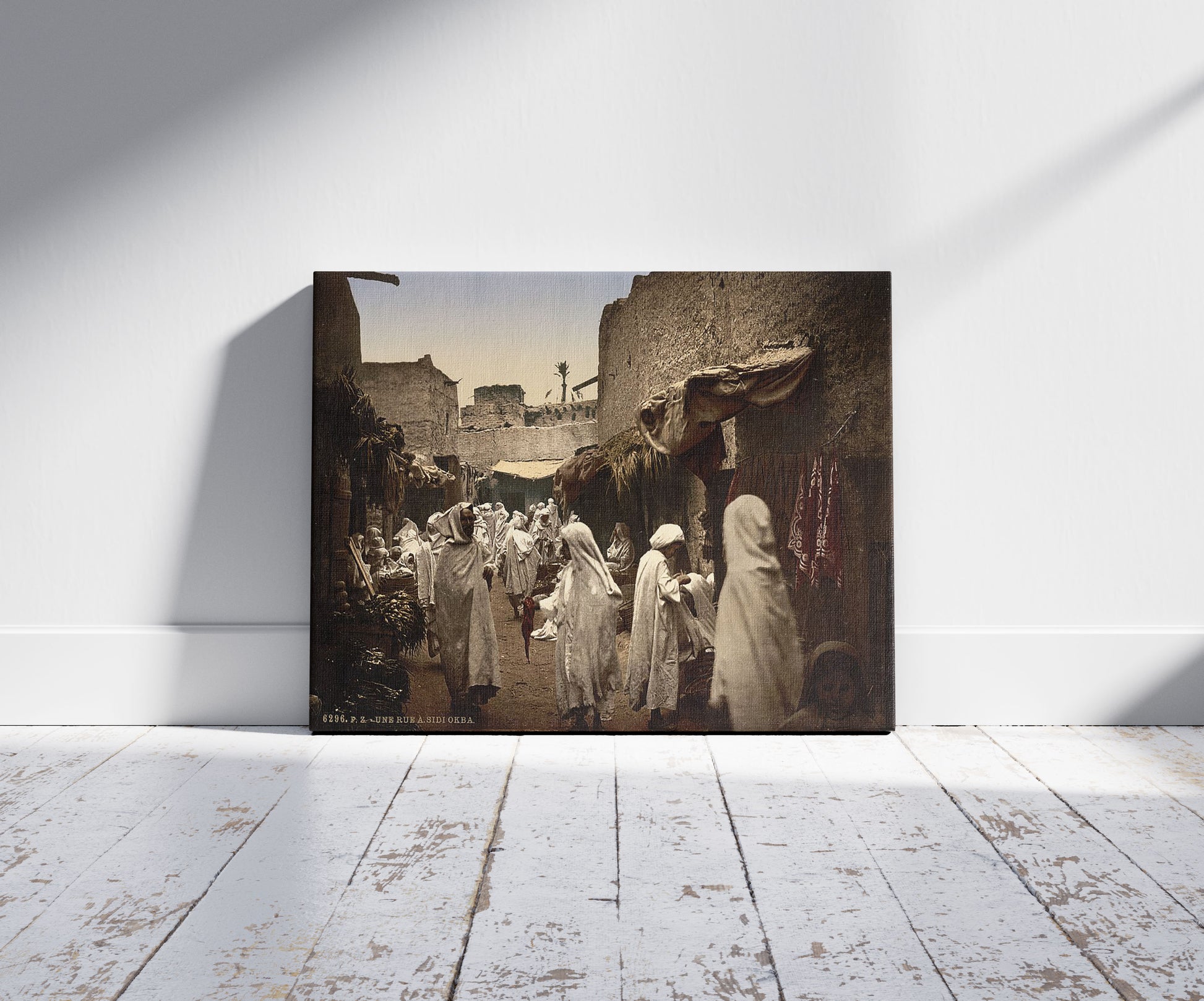 A picture of A street, Sidi Okba, Algeria, a mockup of the print leaning against a wall