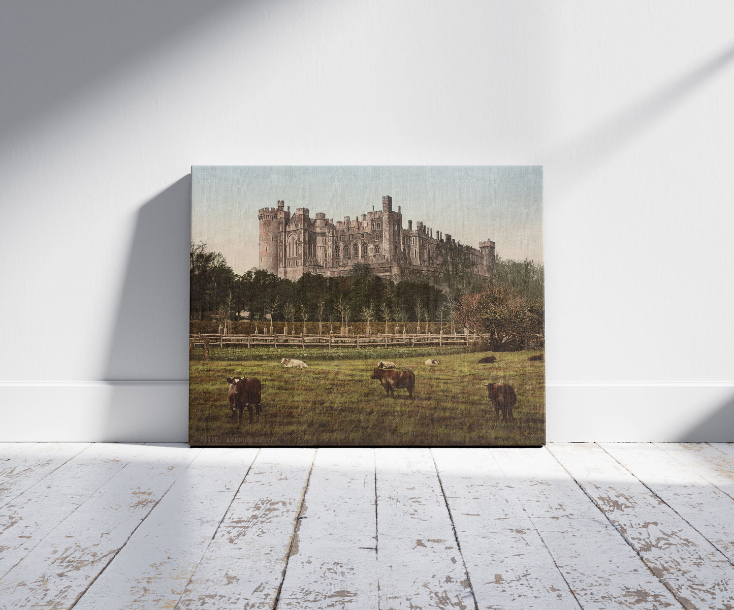 A picture of Arundel Castle, a mockup of the print leaning against a wall