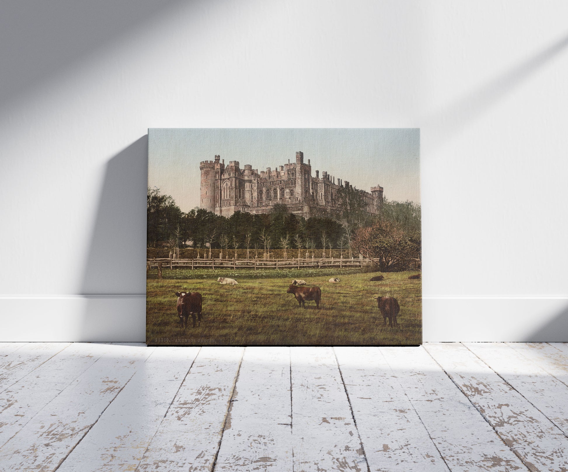 A picture of Arundel Castle, a mockup of the print leaning against a wall