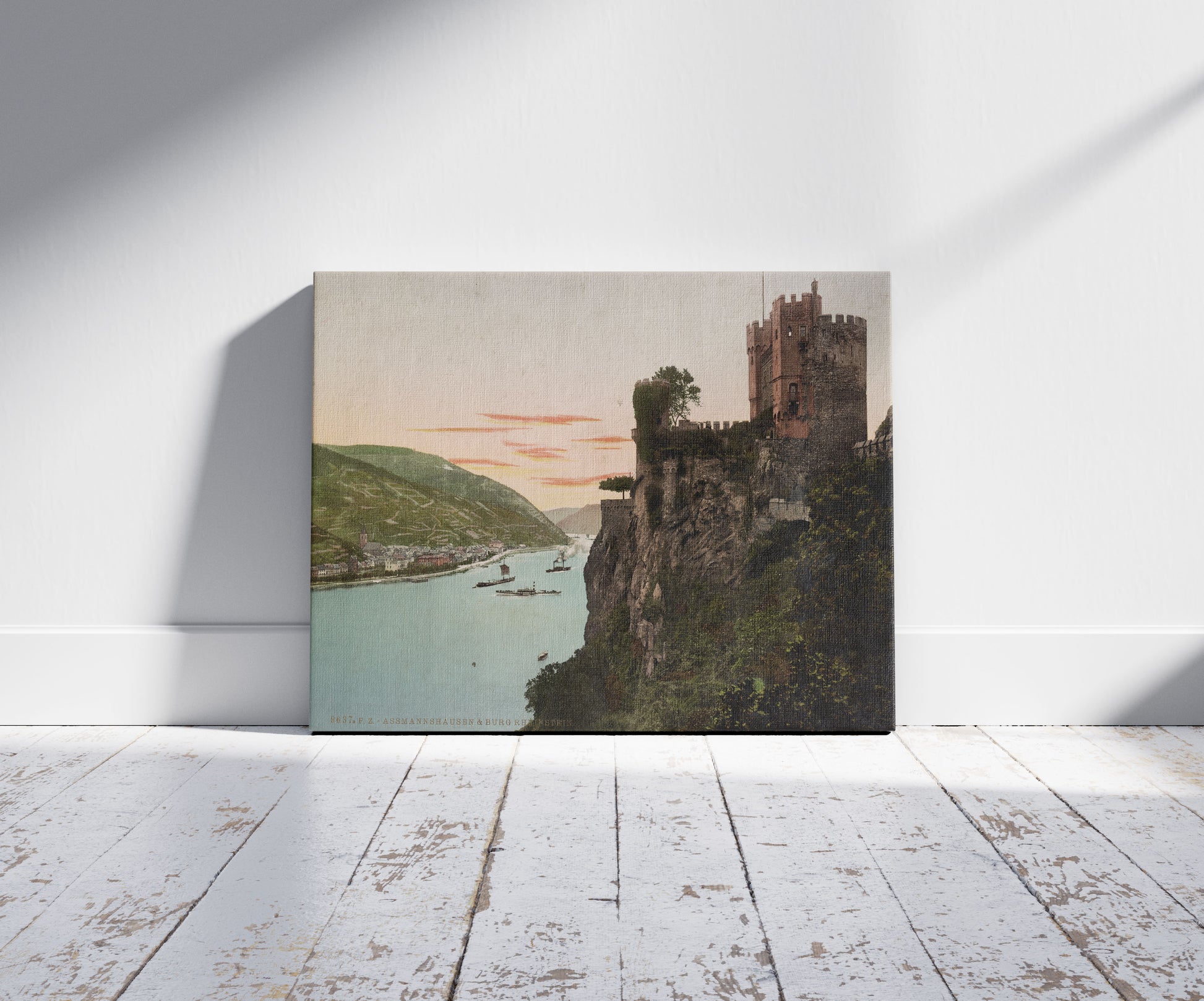 A picture of Assmannshausen & Burg Rheinstein, a mockup of the print leaning against a wall