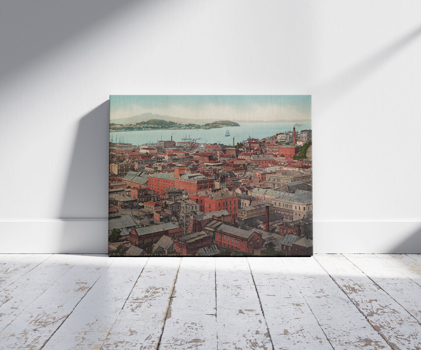 A picture of Auckland, from St. Matthews Tower, a mockup of the print leaning against a wall