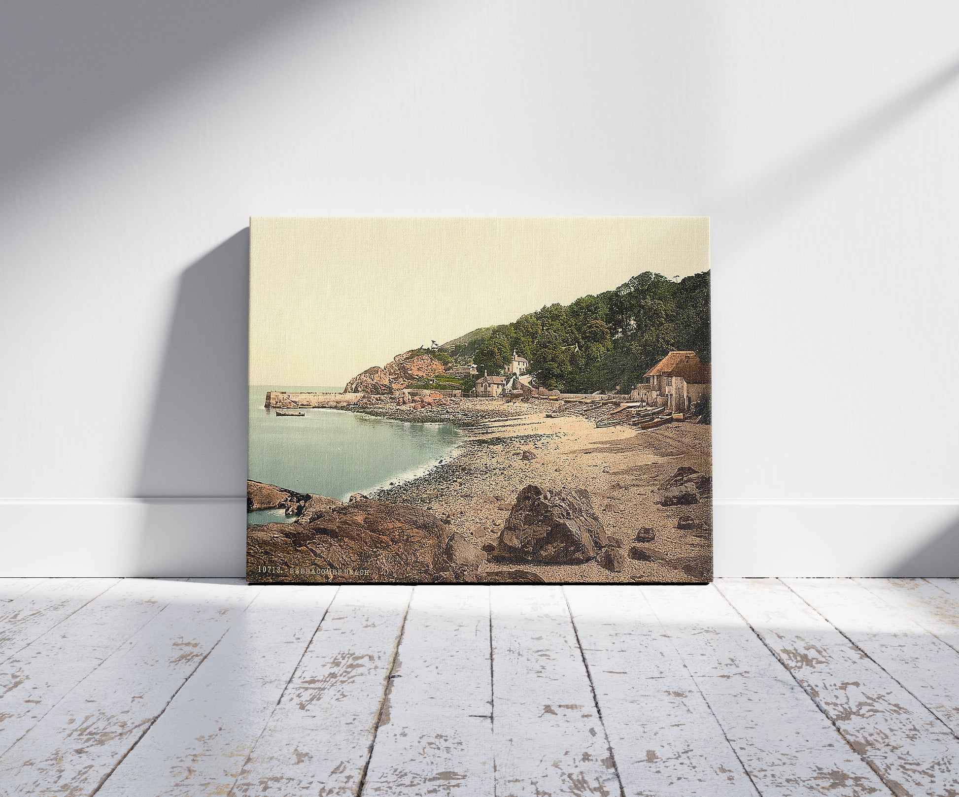 A picture of Babbacombe Beach, Torquay, England, a mockup of the print leaning against a wall