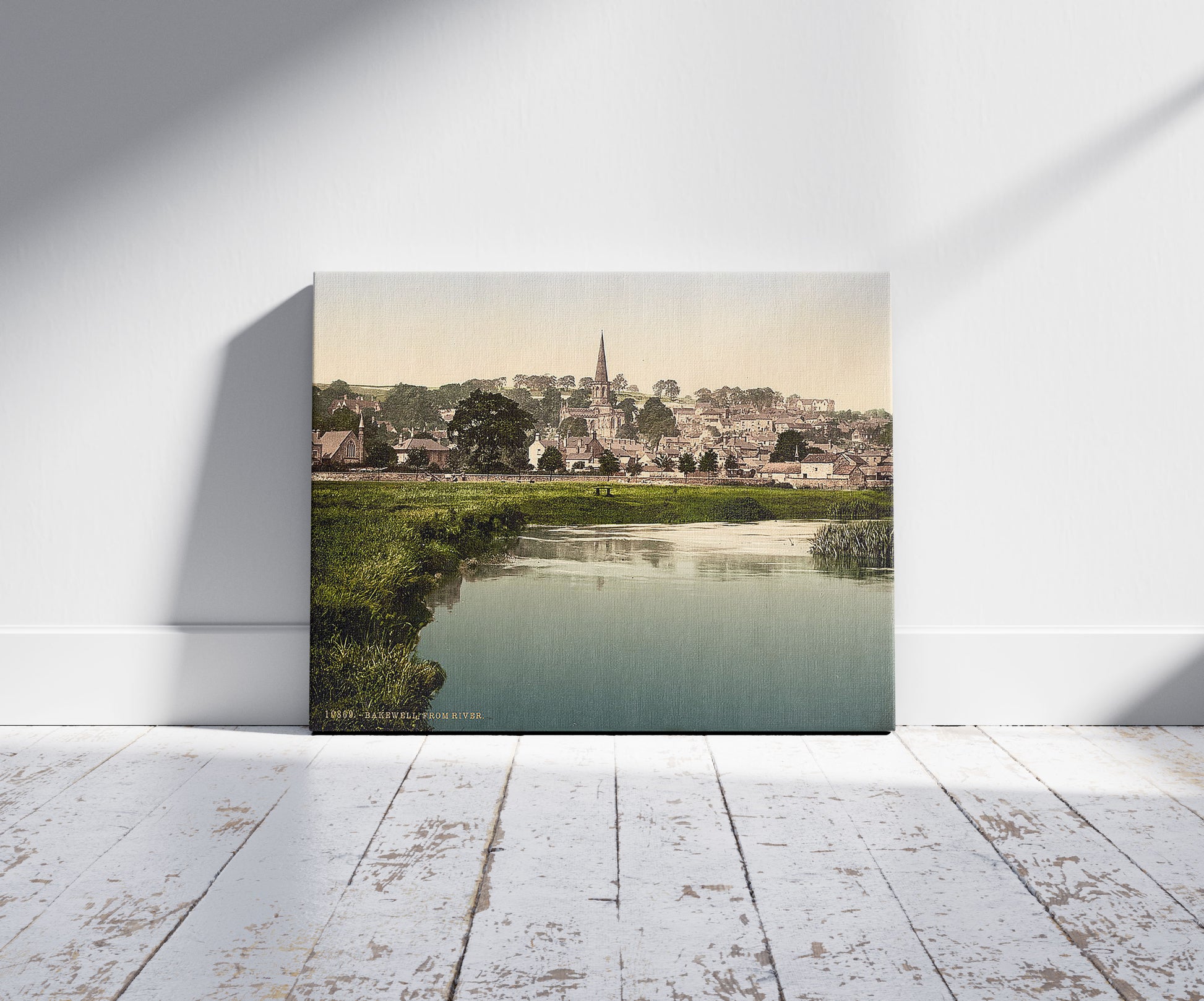 A picture of Bakewell, from river, Derbyshire, England, a mockup of the print leaning against a wall